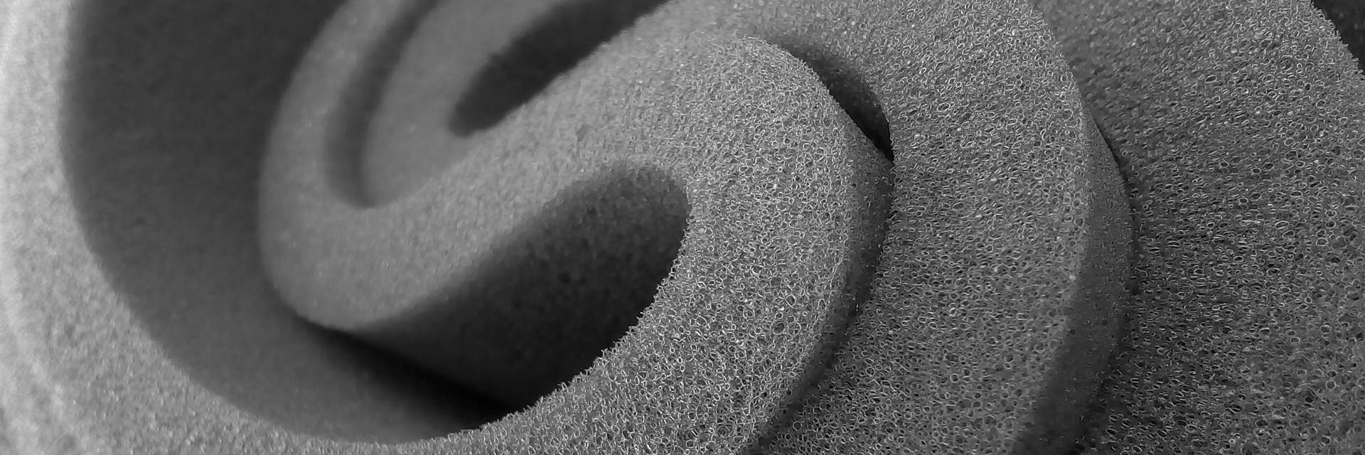 an abstract photo of a curved building with a blue sky in the background