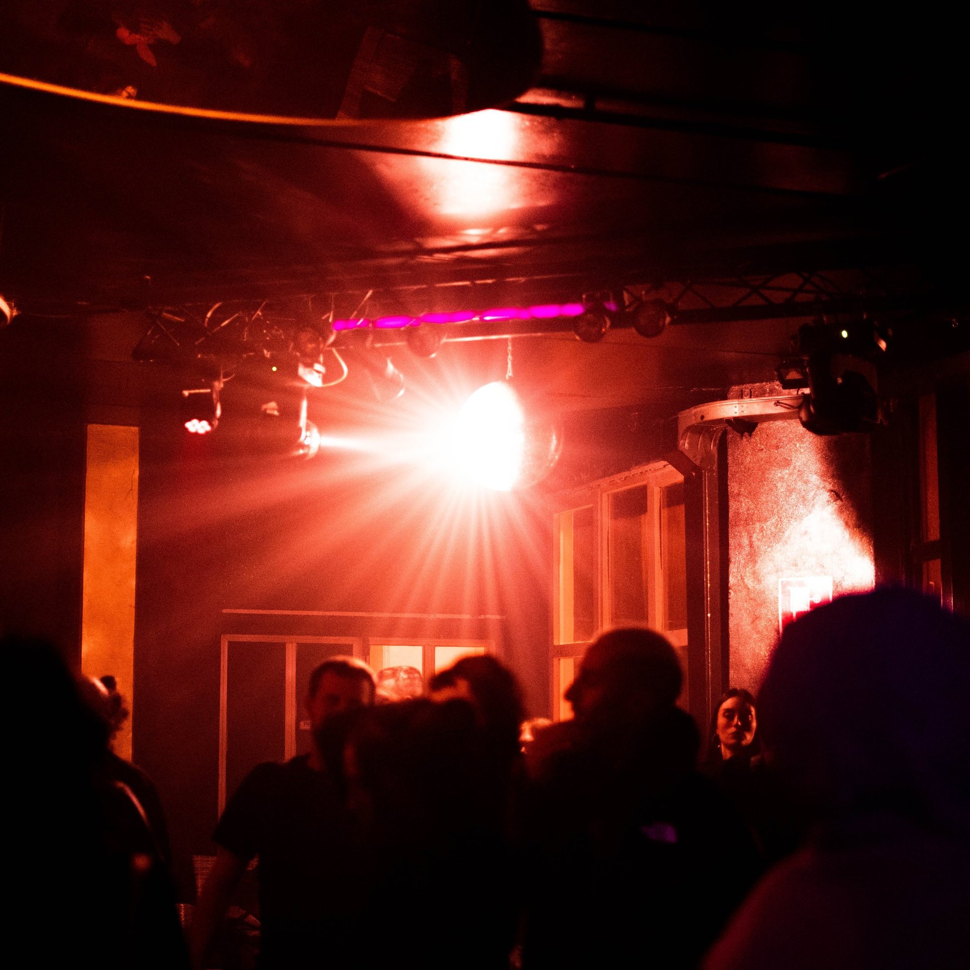 an abstract photo of a curved building with a blue sky in the background