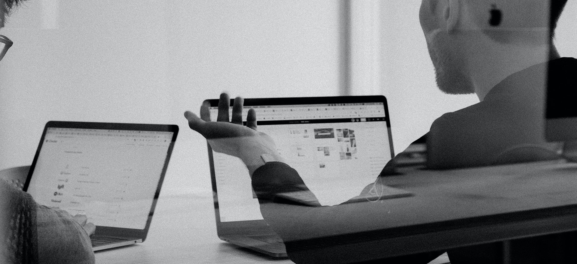 grayscale photo of person using MacBook