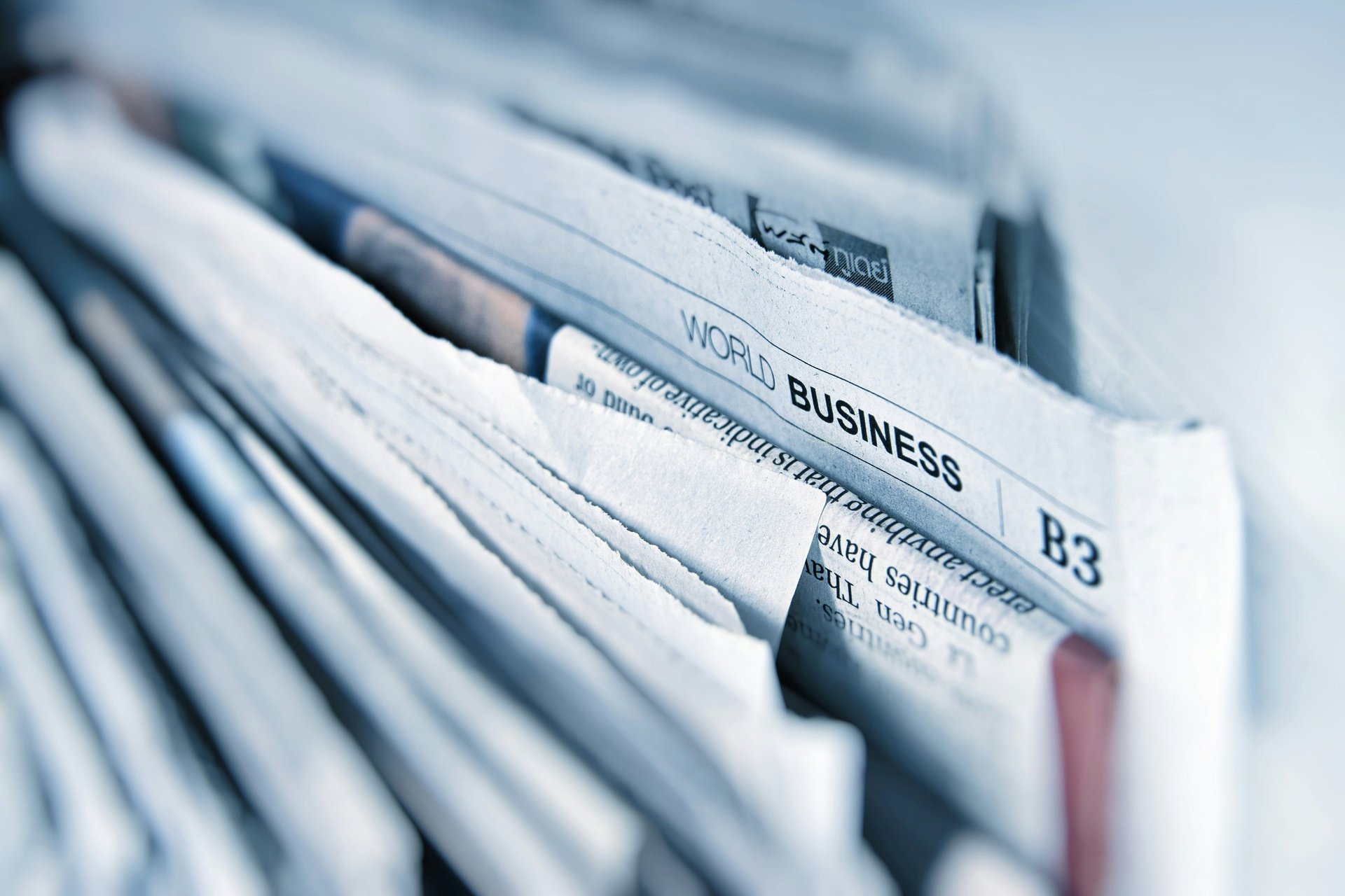 a stack of newspapers sitting on top of a table