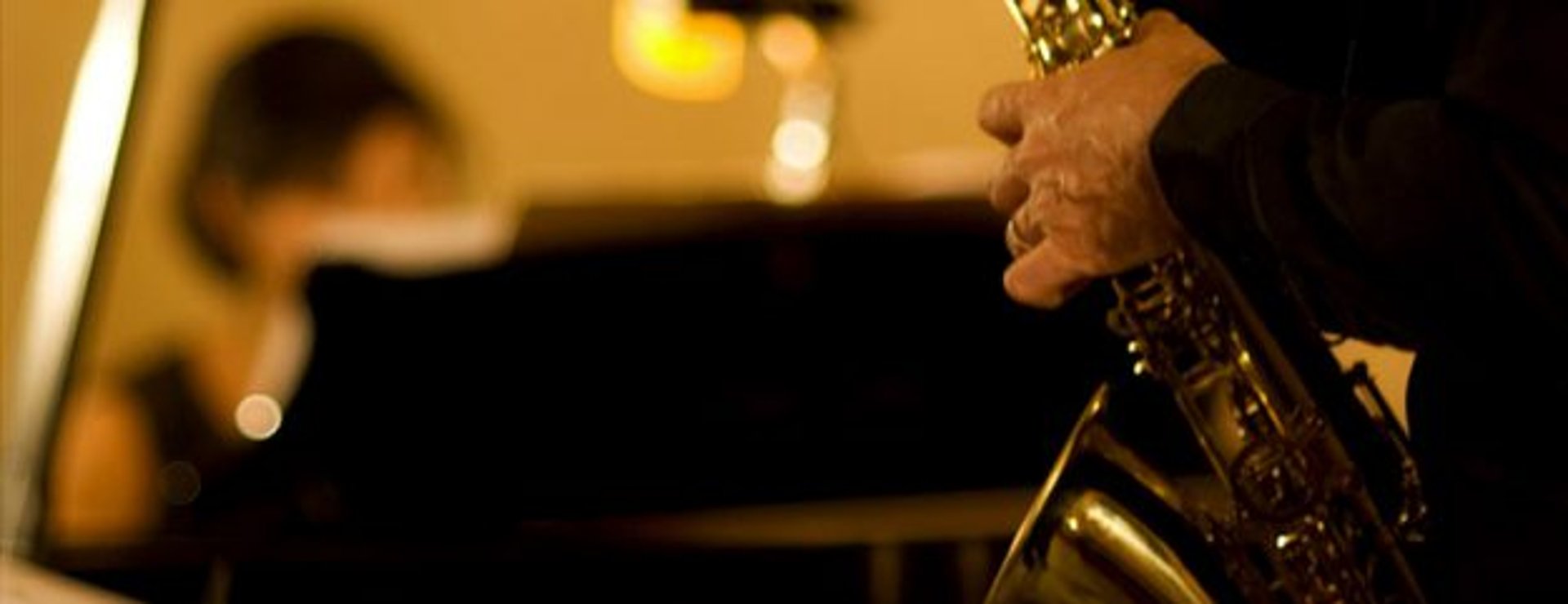 person playing gold trumpet