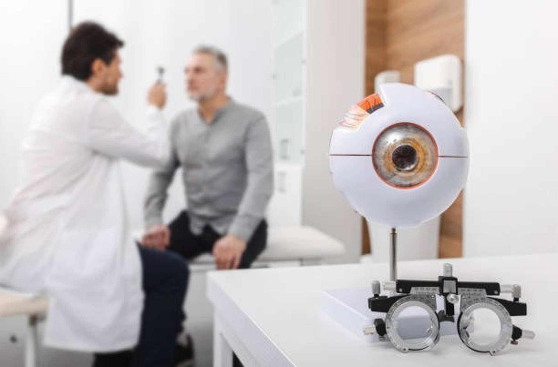 a group of different colored buttons on a pink surface