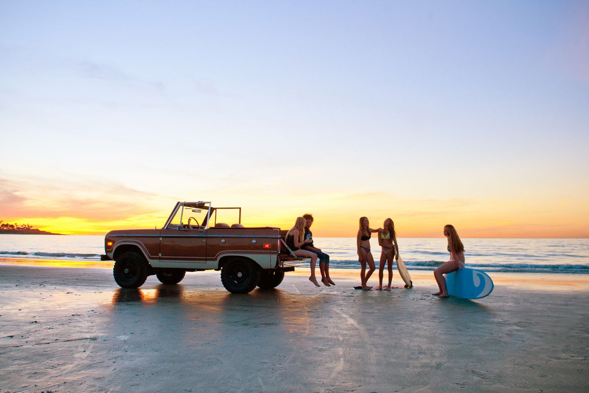 silhouette photography of two coconut trees near body water during golden hour