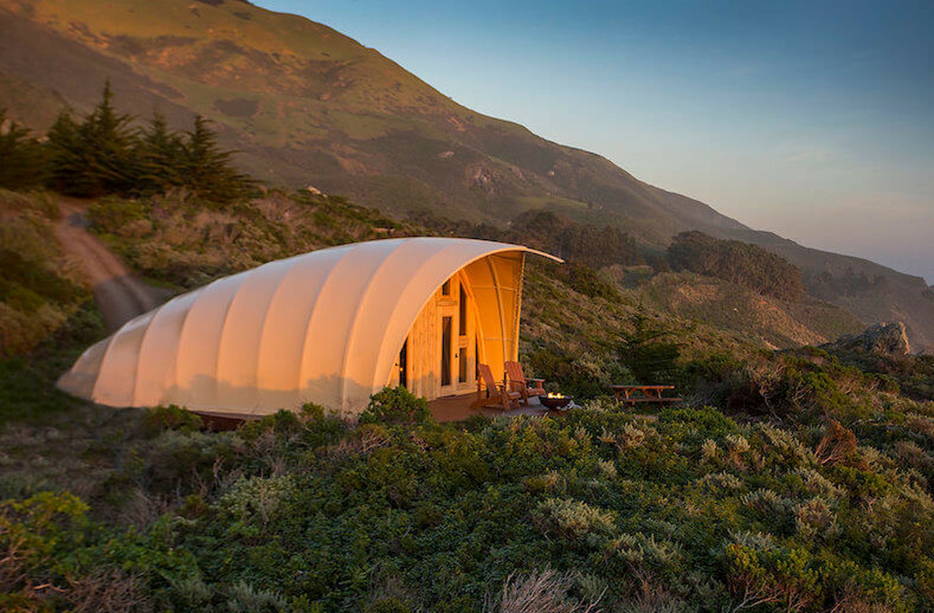 silhouette photography of two coconut trees near body water during golden hour