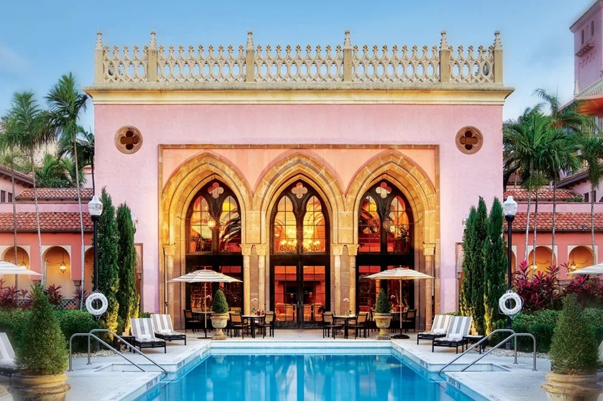 silhouette photography of two coconut trees near body water during golden hour