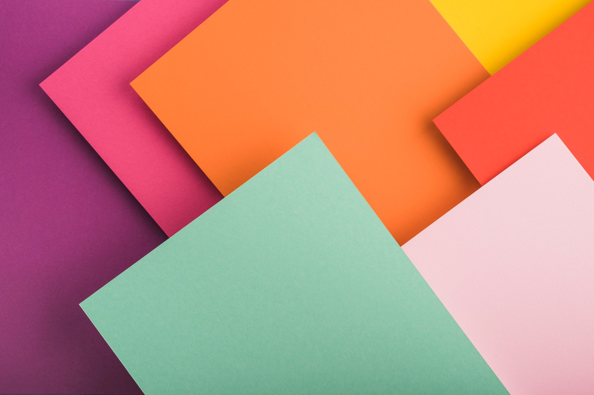 a close up of three different colors of paper