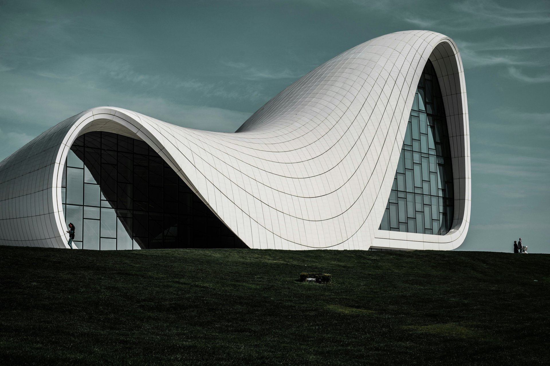 an abstract photo of a curved building with a blue sky in the background