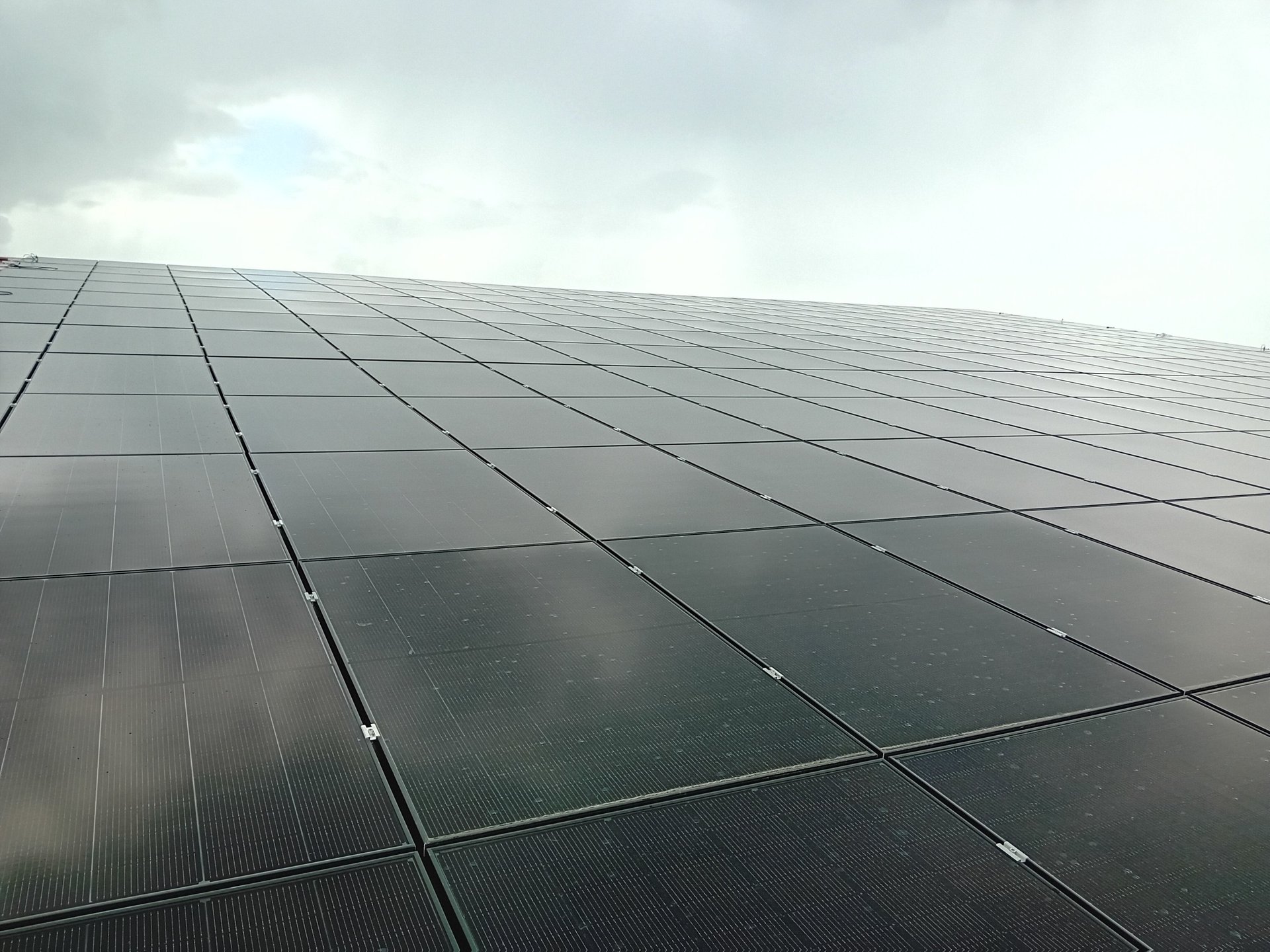 an abstract photo of a curved building with a blue sky in the background