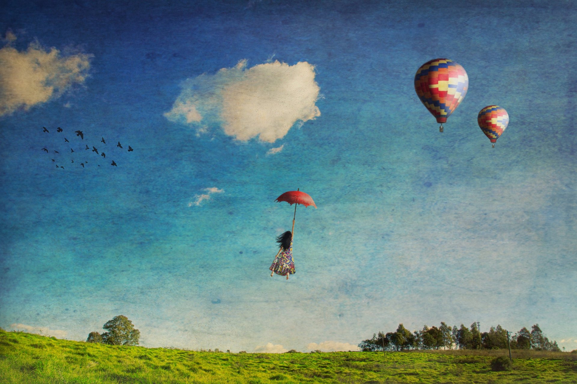 Fine art surreal portrait of a female flying in the sky while holding a red umbrella Sydney creative conceptual photography