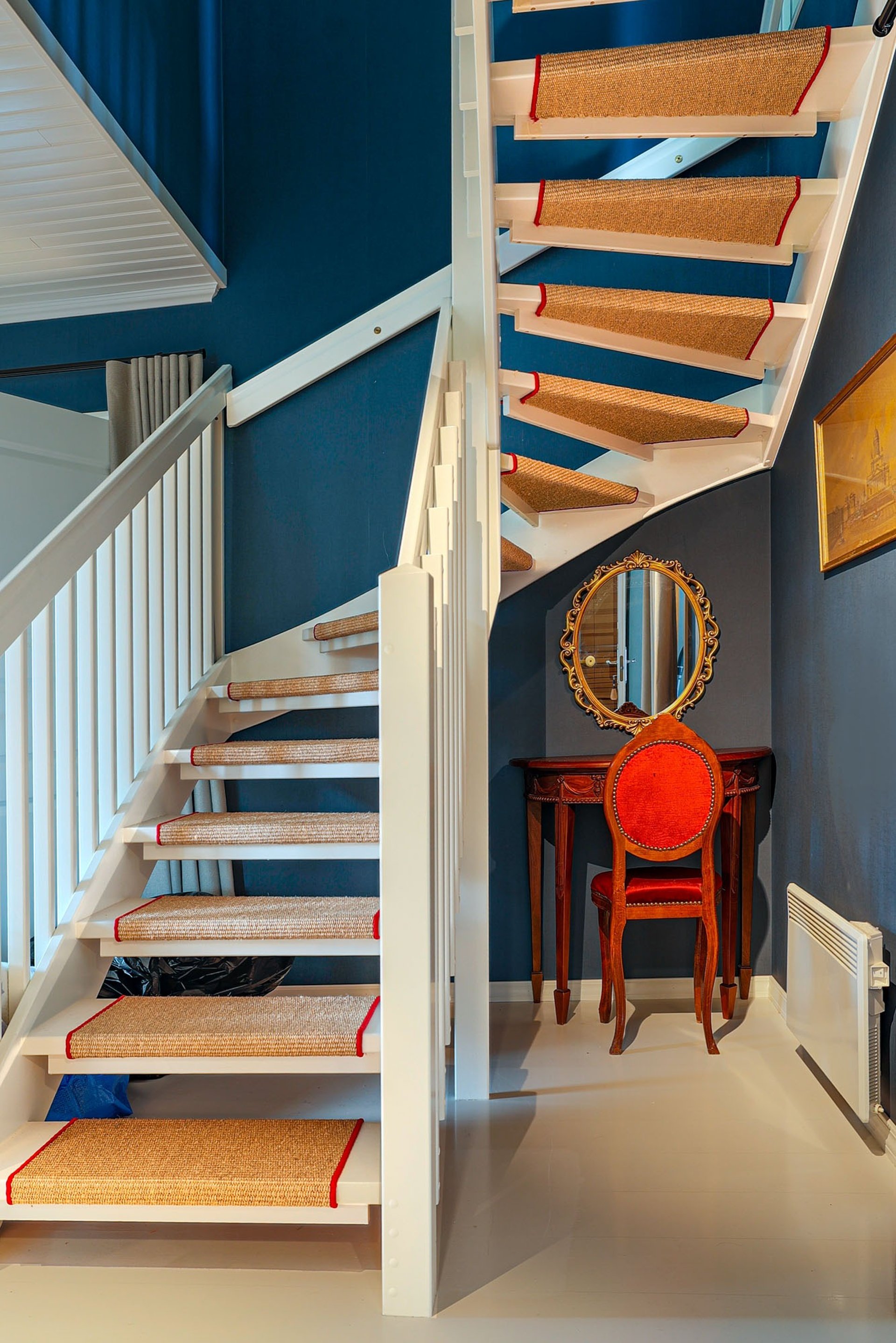 white cat sleeps under white comforter