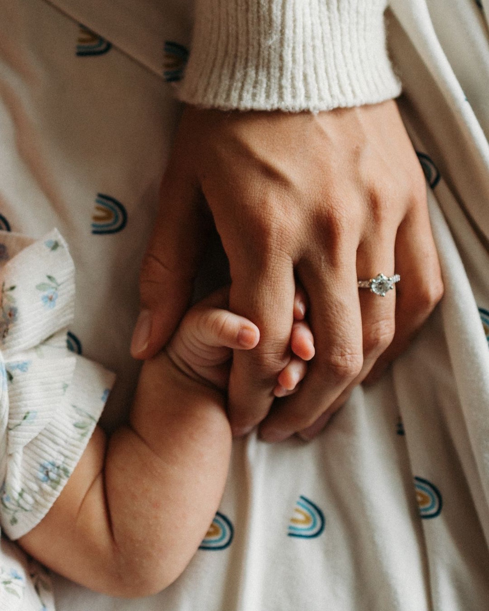 a close up of a person holding a baby