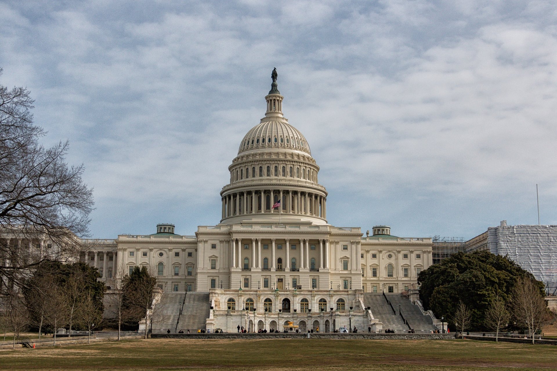 woman wearing yellow long-sleeved dress under white clouds and blue sky during daytime