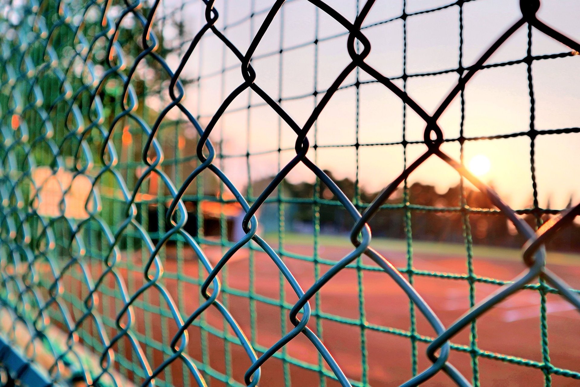 padlock on gray chain link fence