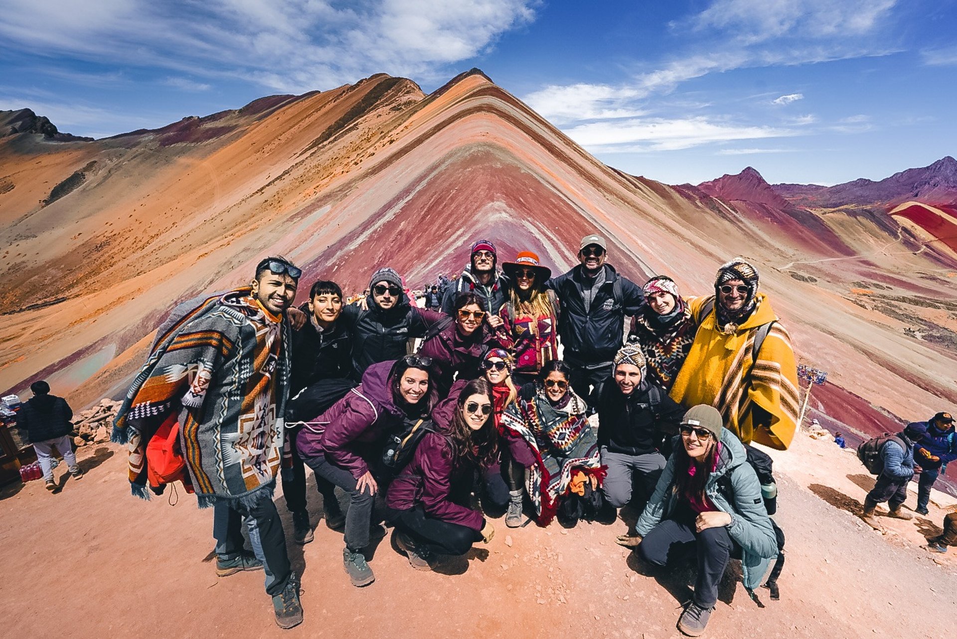 a woman in a blue dress standing in front of a pond