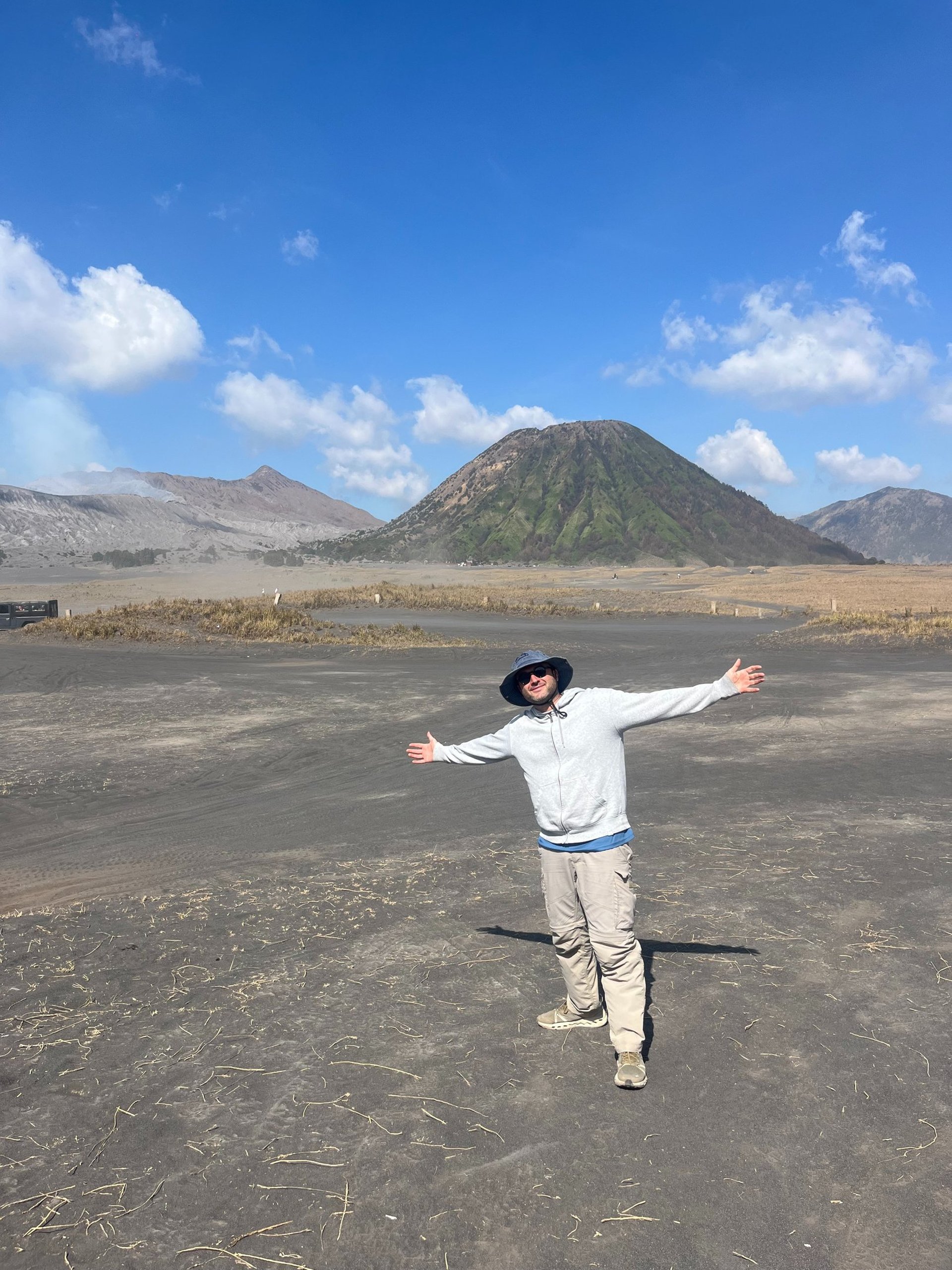 woman wearing yellow long-sleeved dress under white clouds and blue sky during daytime