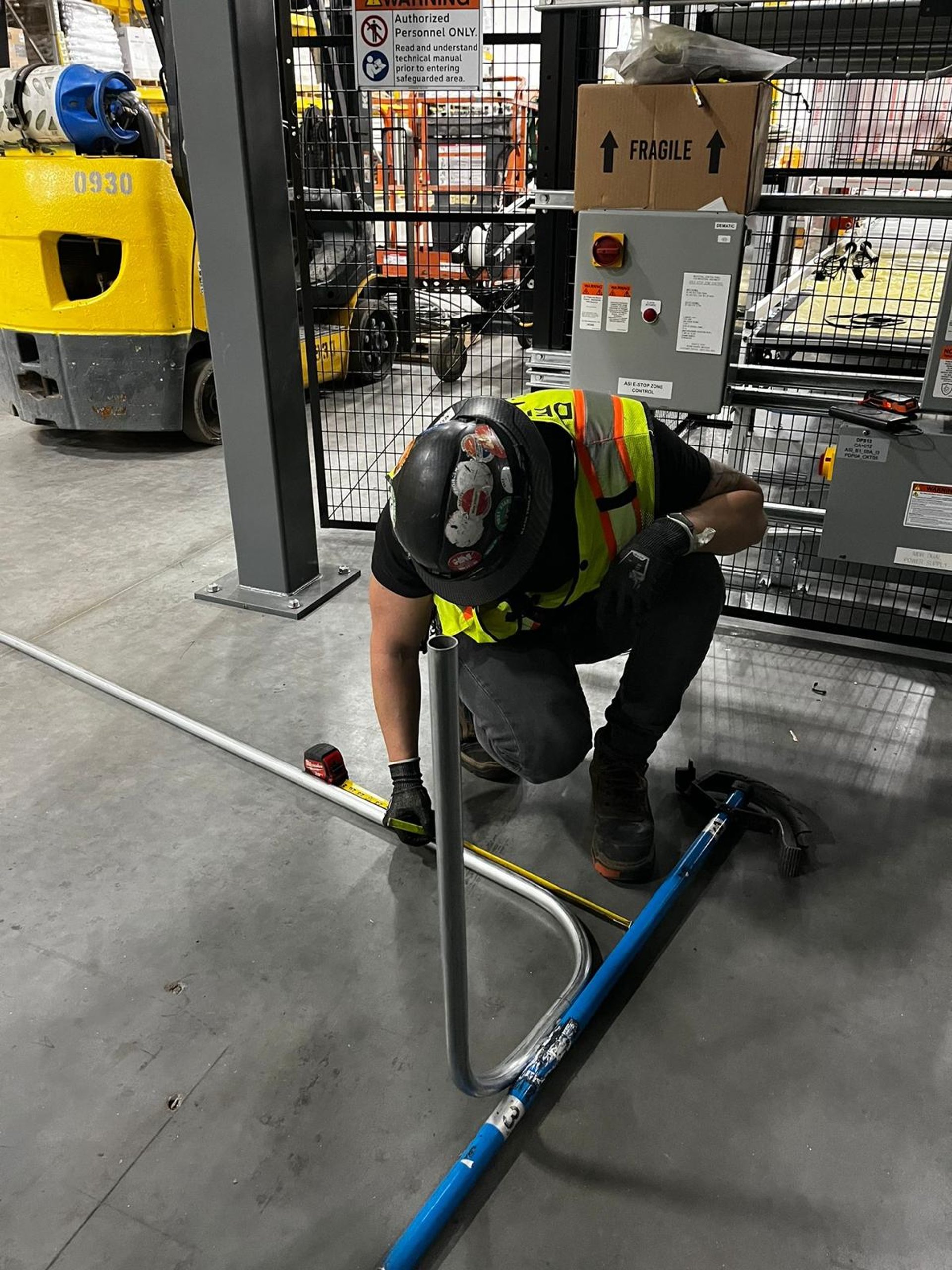 man in brown hat holding black and gray power tool