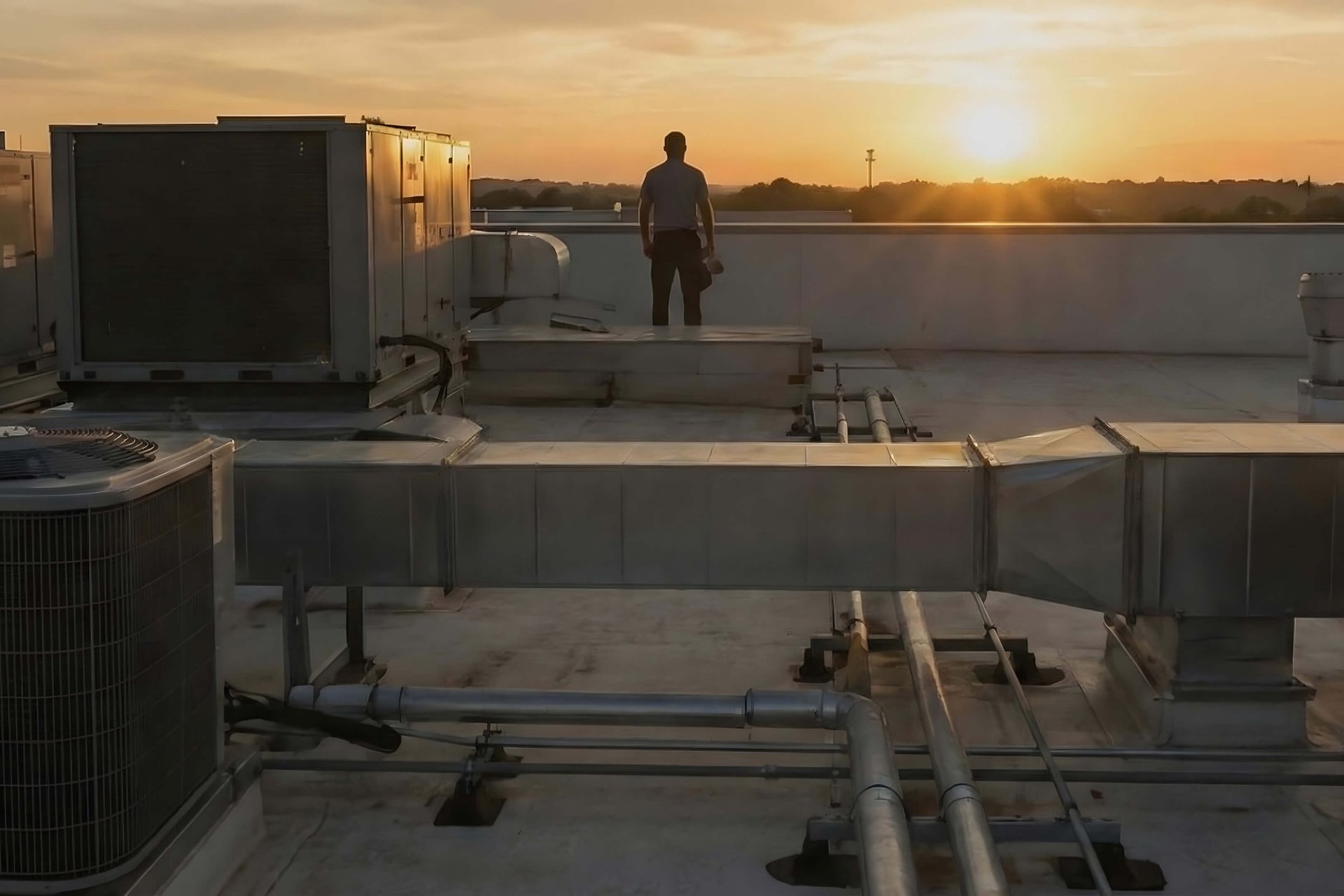 Stan Cortland business broker on-site with contractor and HVAC units representing a successful business exit.