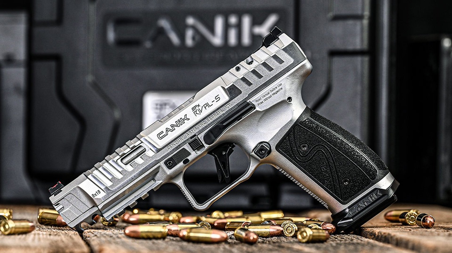 a close up of a gun on a black surface