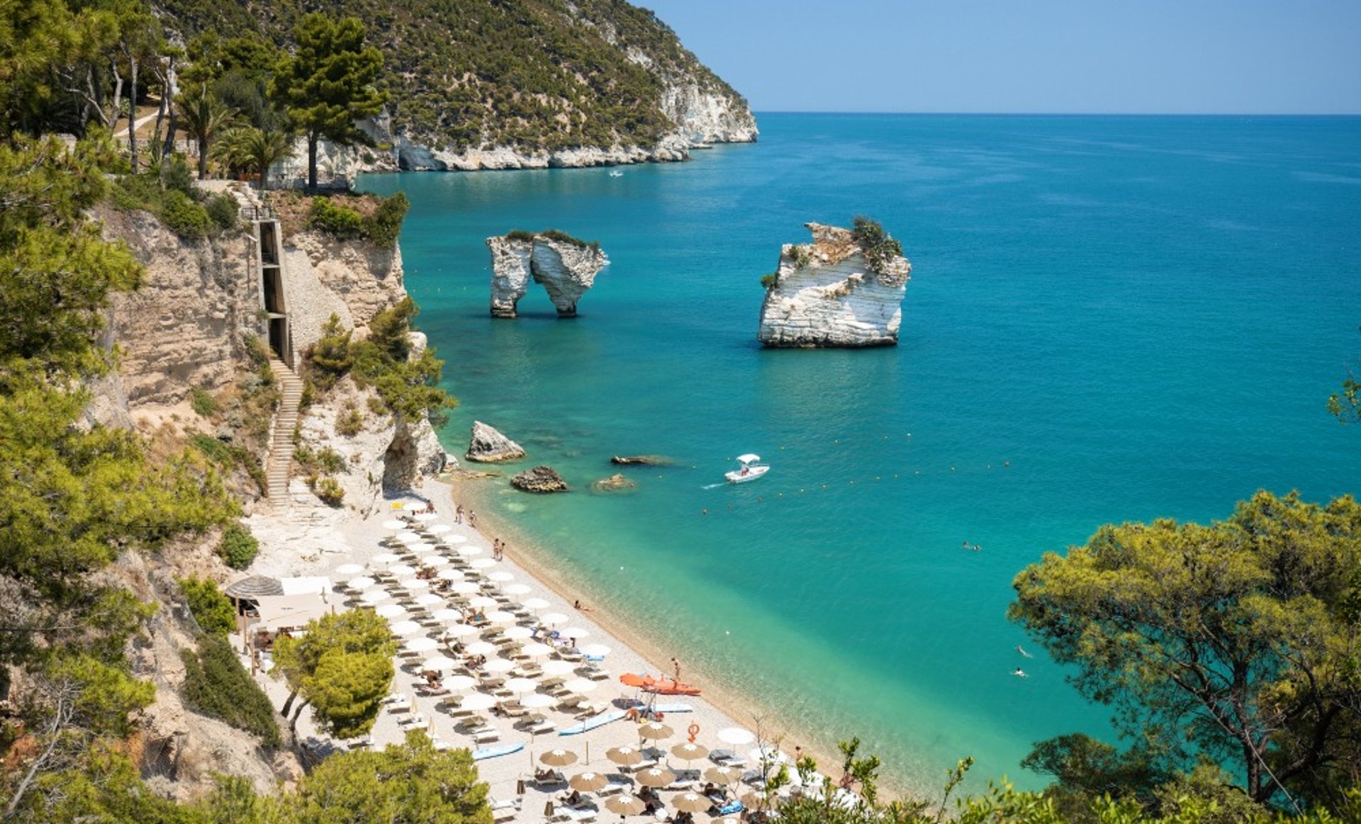 white plastic chairs and table near brown concrete building during daytime