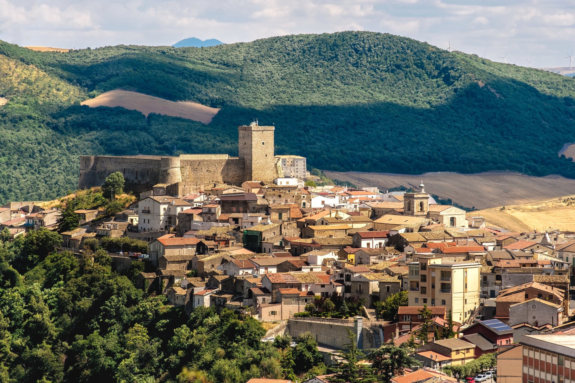 people riding on blue and white boat on water near buildings during daytime