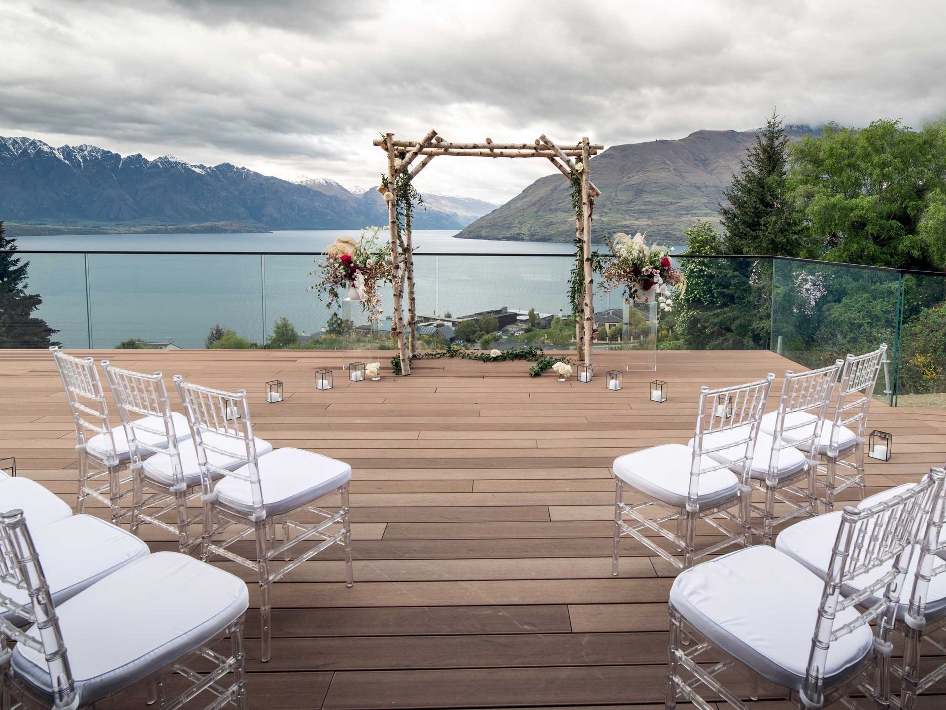 two decorative chairs on grass field near body of water