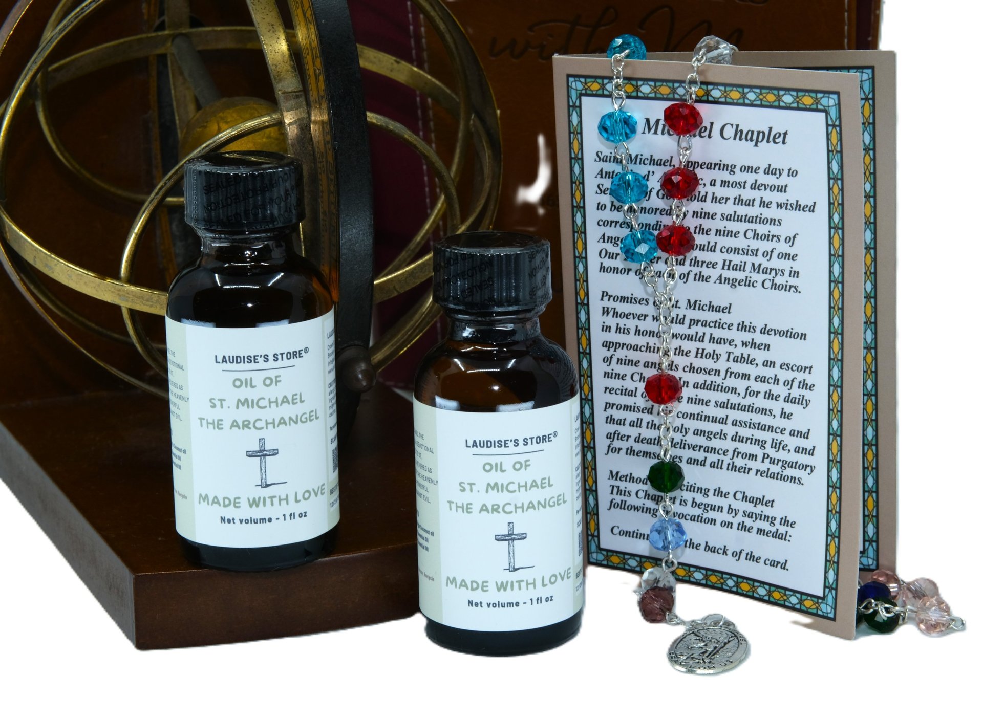Two bottles of St Michael oil and a St. Michael Chaplet on a table