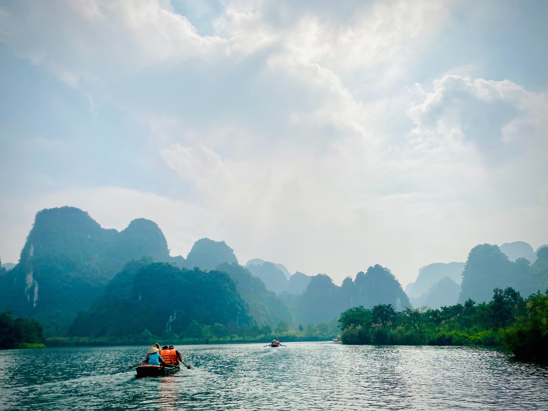 high-angle photography of boats on water near hill during daytime