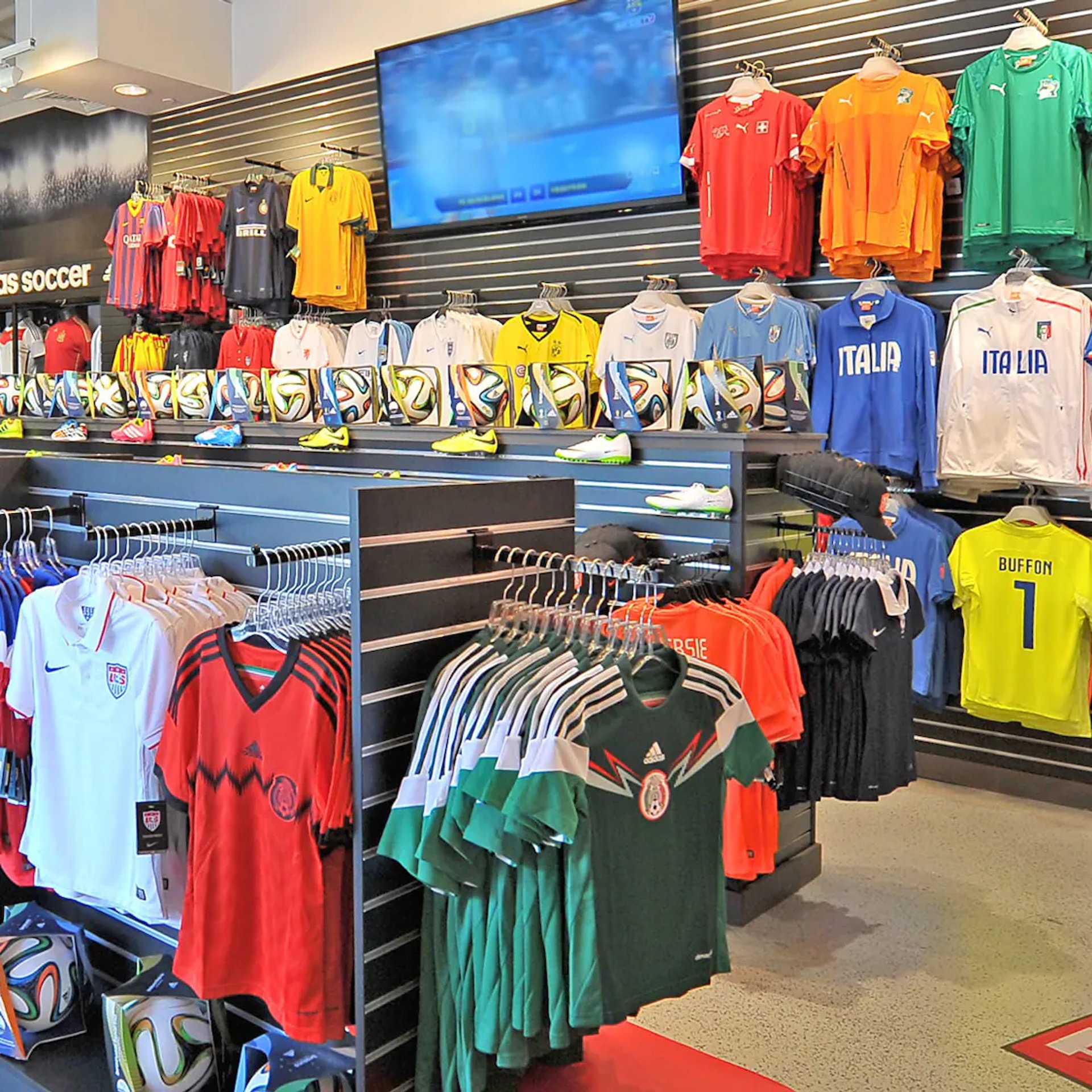 a store filled with lots of red and black shirts