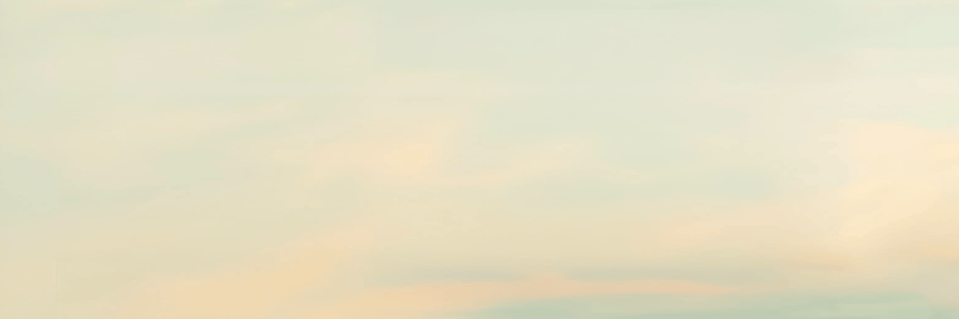 an abstract photo of a curved building with a blue sky in the background