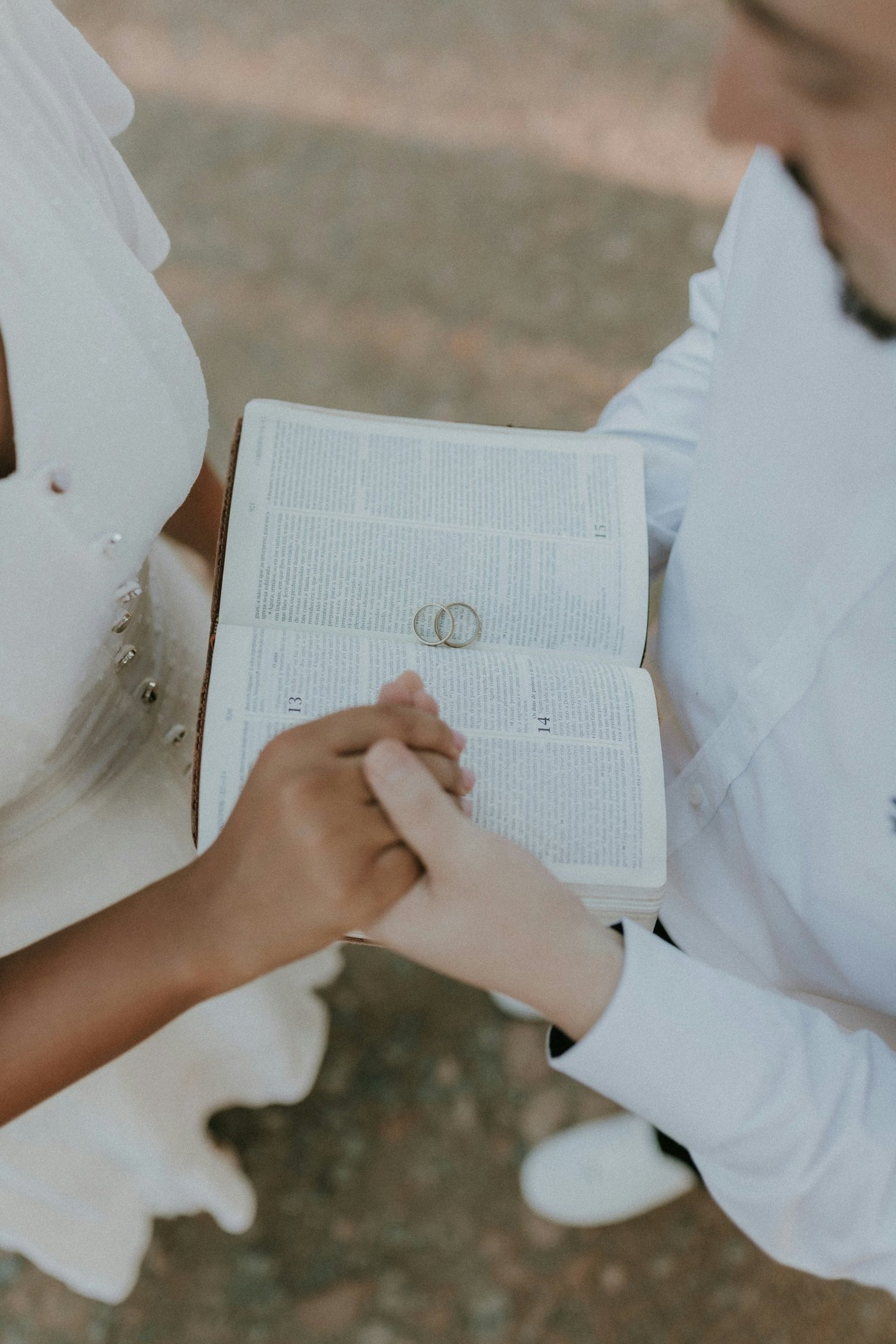 woman in white wedding dress standing near brown leaves during daytime