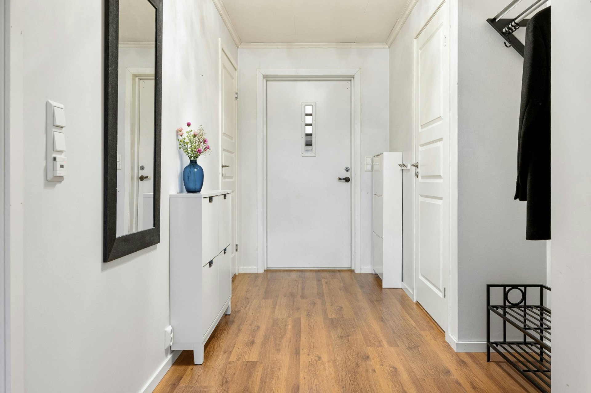 white and gray wooden house near green trees during daytime