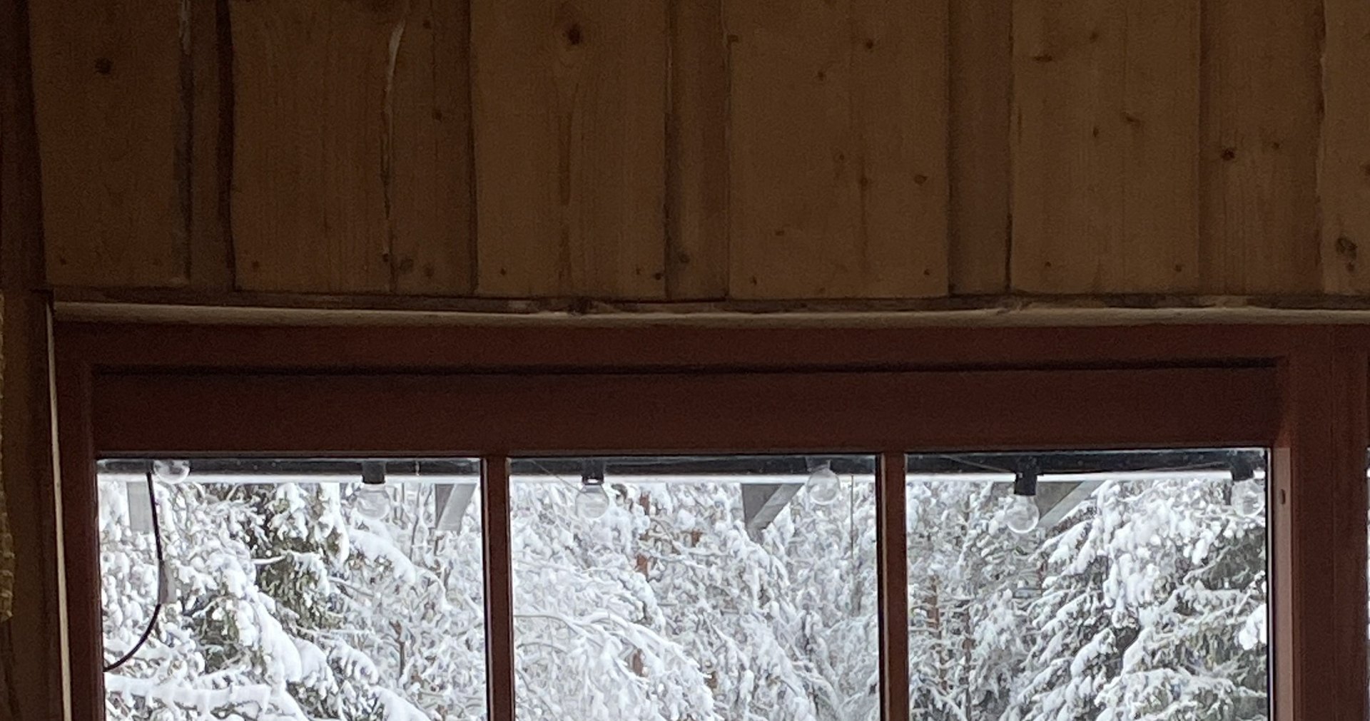 A man in a black suit loosening his tie