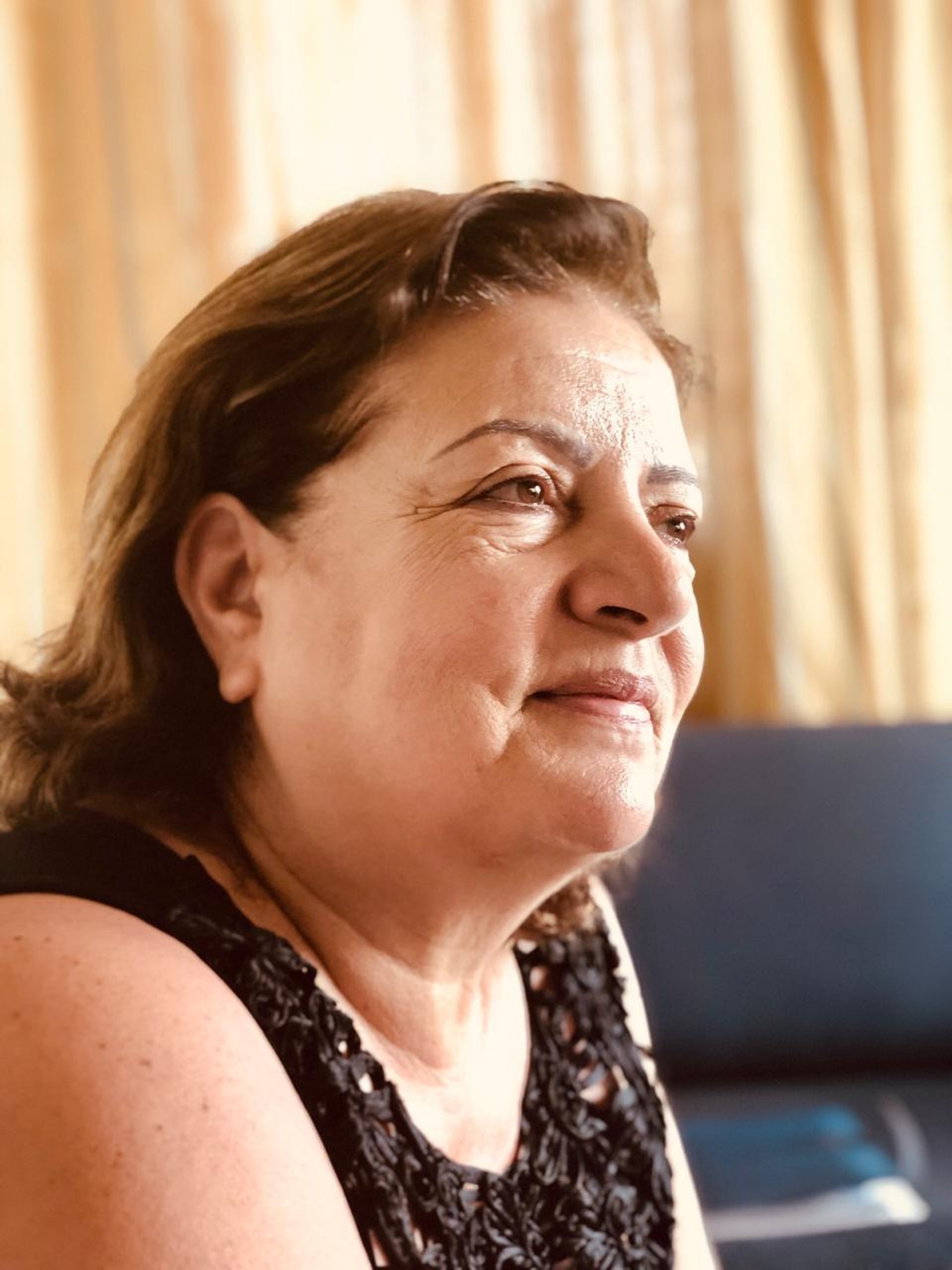 man sitting beside two woman on gray surface