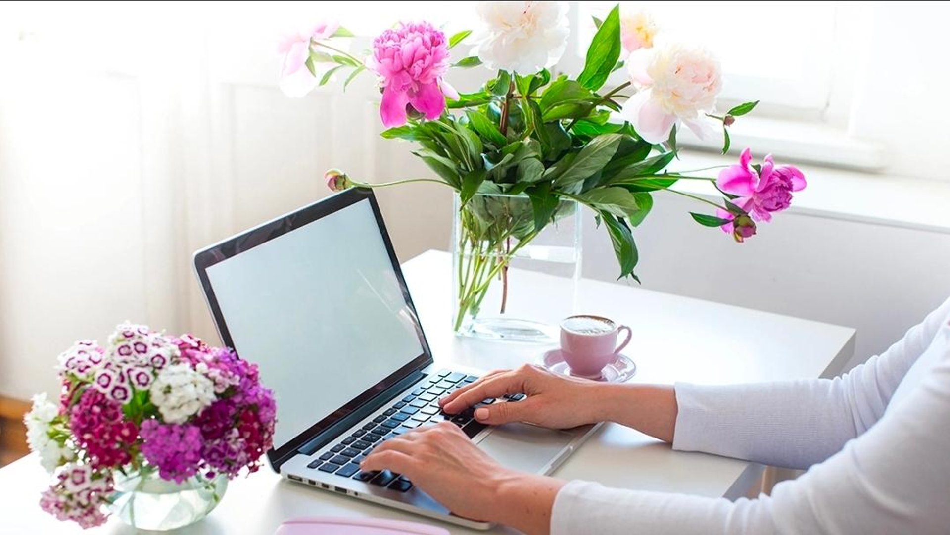 coffee latte near white wireless keyboard and Apple EarPods on the table photography