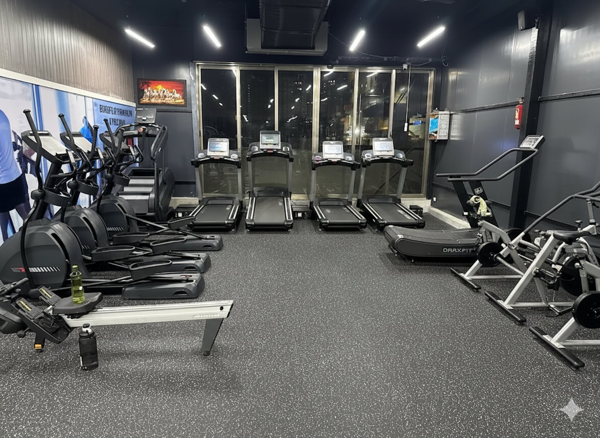 a row of exercise machines in a gym