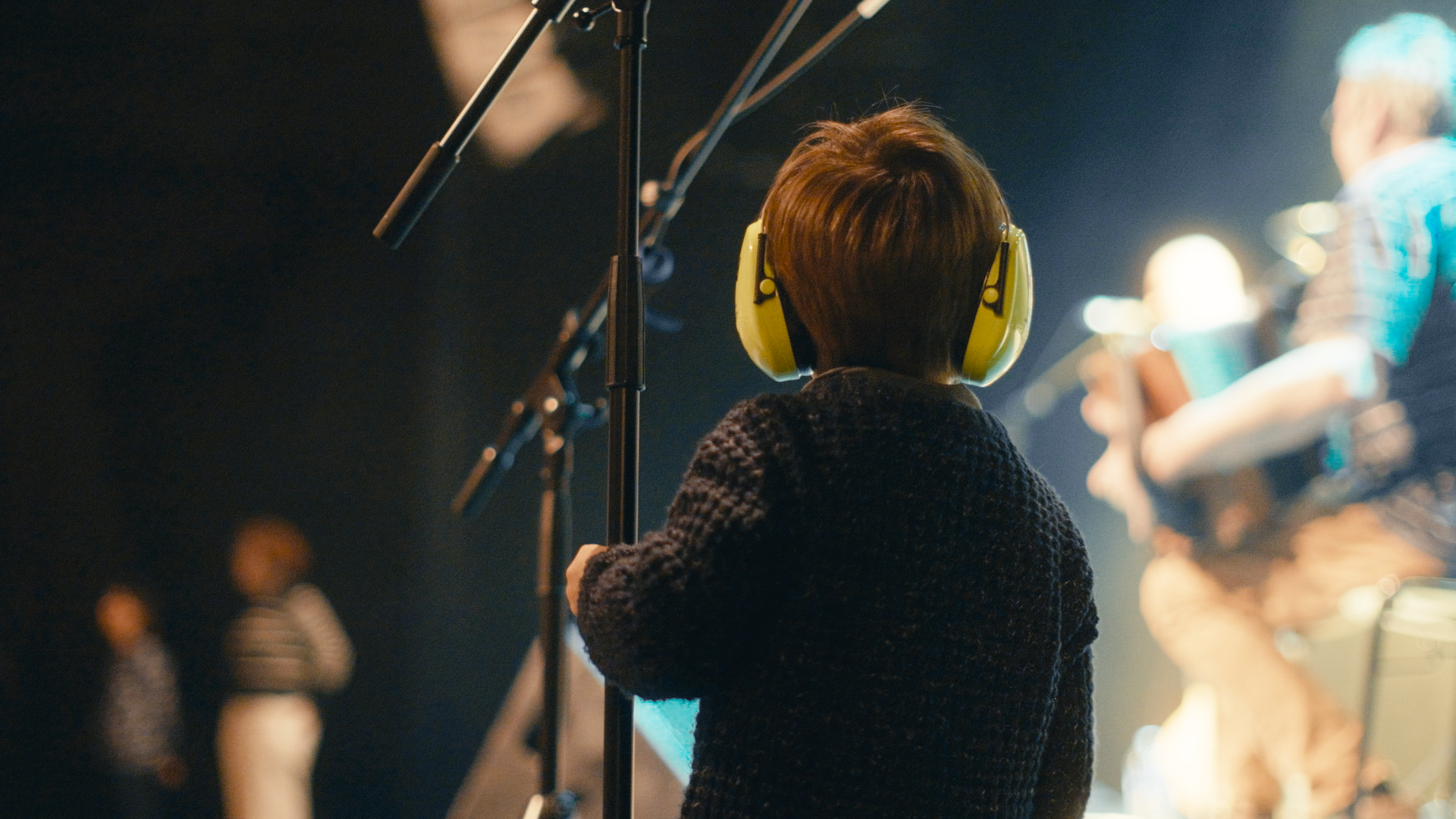 pen near black lined paper and eyeglasses
