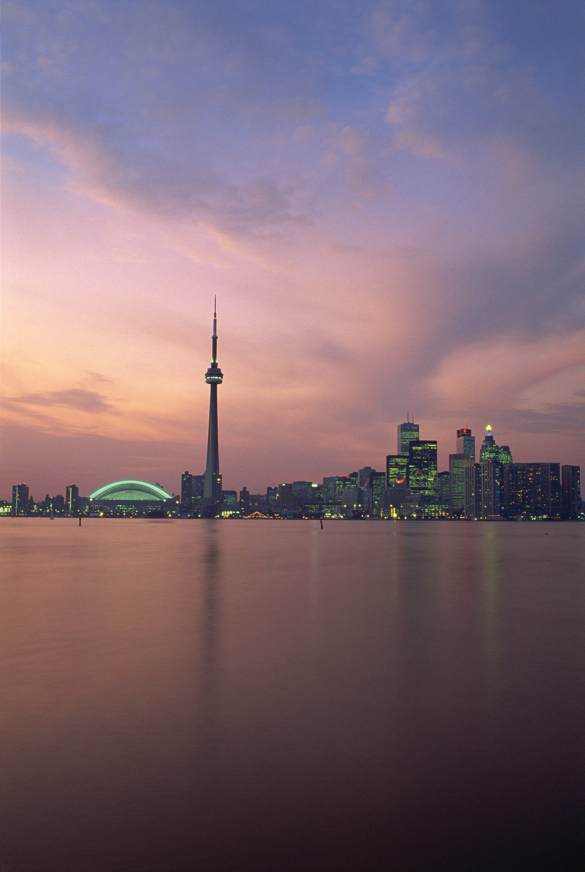 woman wearing yellow long-sleeved dress under white clouds and blue sky during daytime