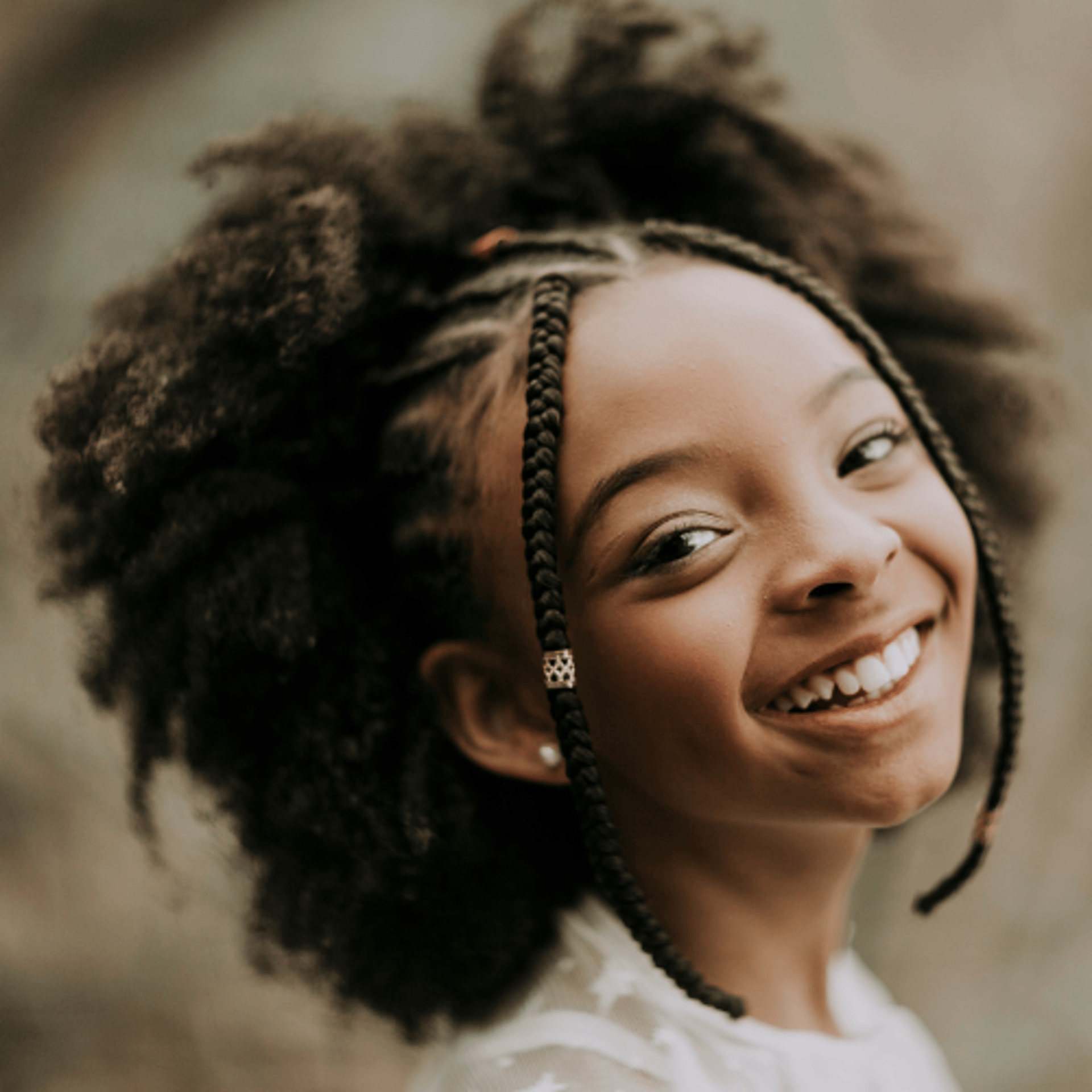 a woman with an afro is looking at the camera