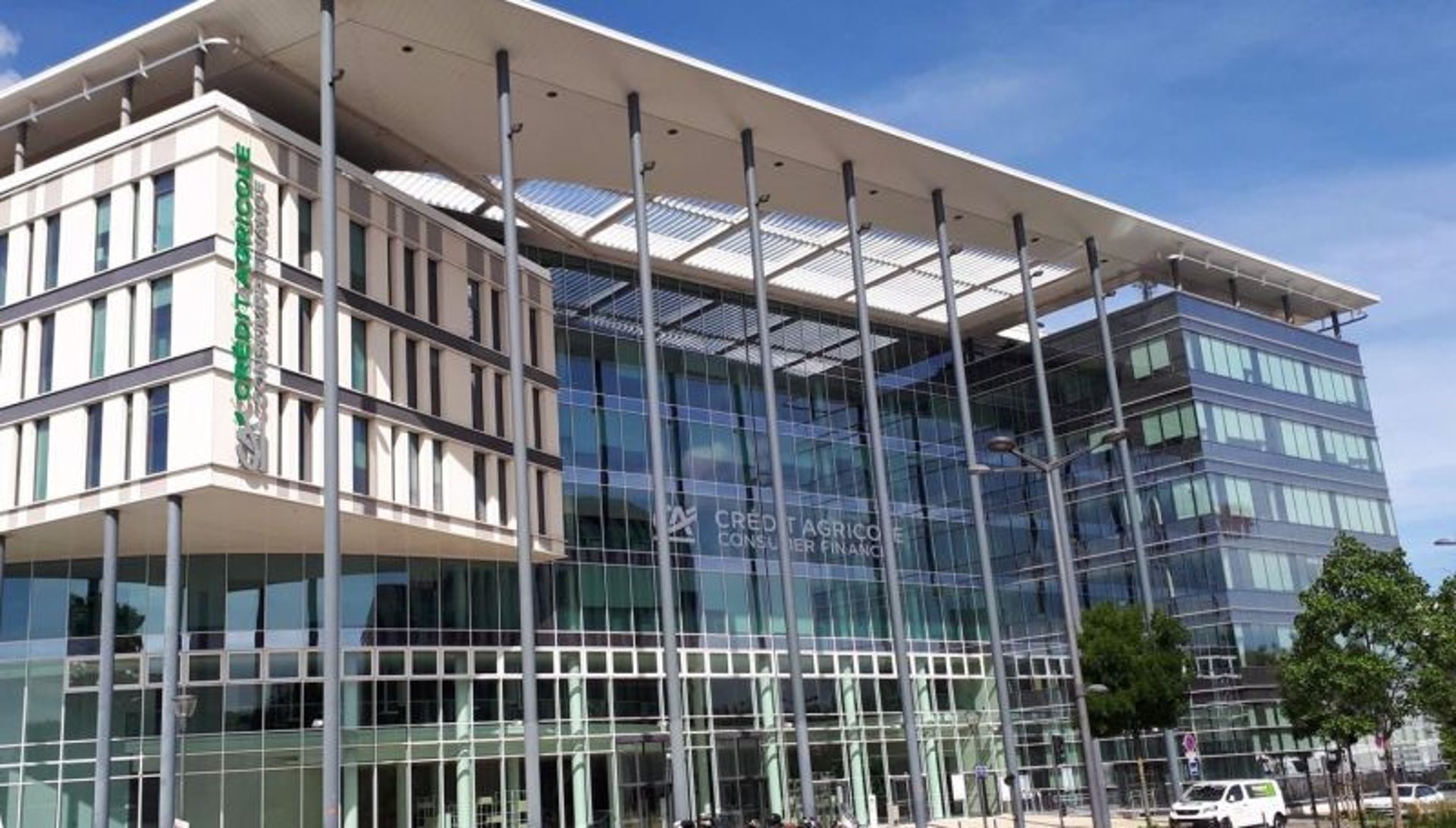 an abstract photo of a curved building with a blue sky in the background