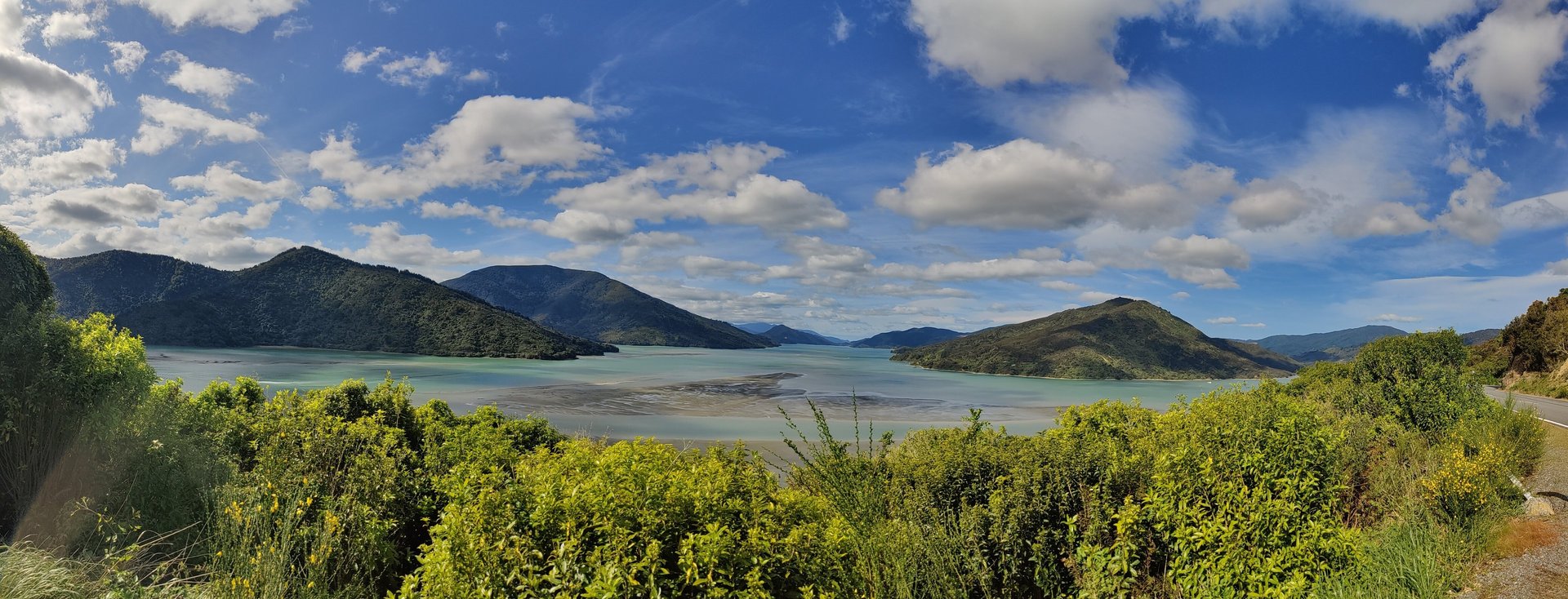 South island New Zealand hills and turquoise water and blue sky