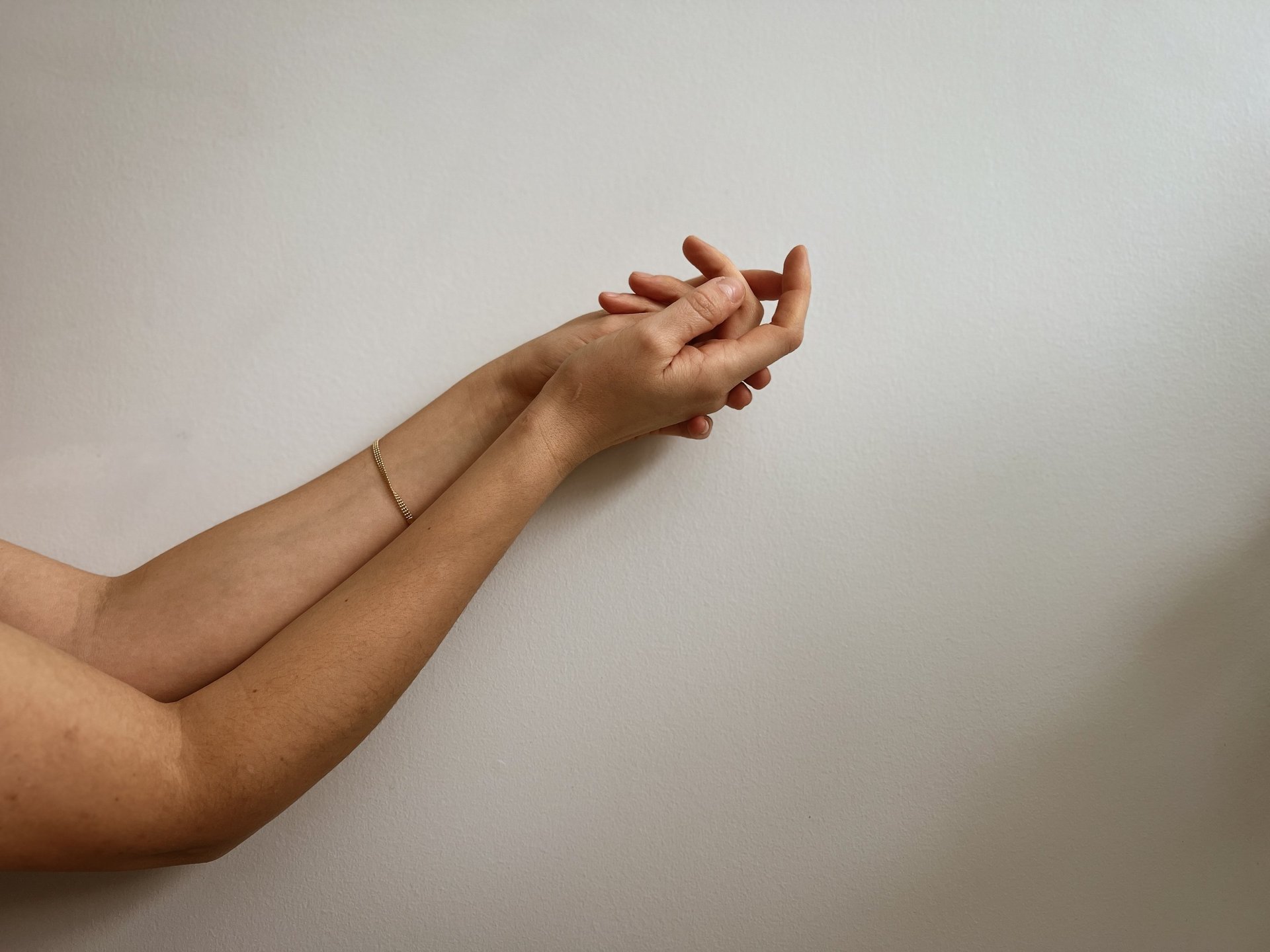 two hands about to hold wallpaper