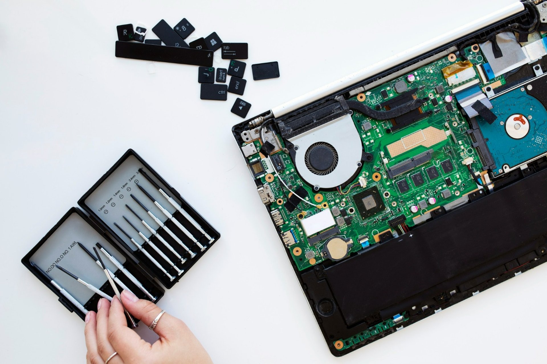 A laptop with a keyboard and a mouse on top of it