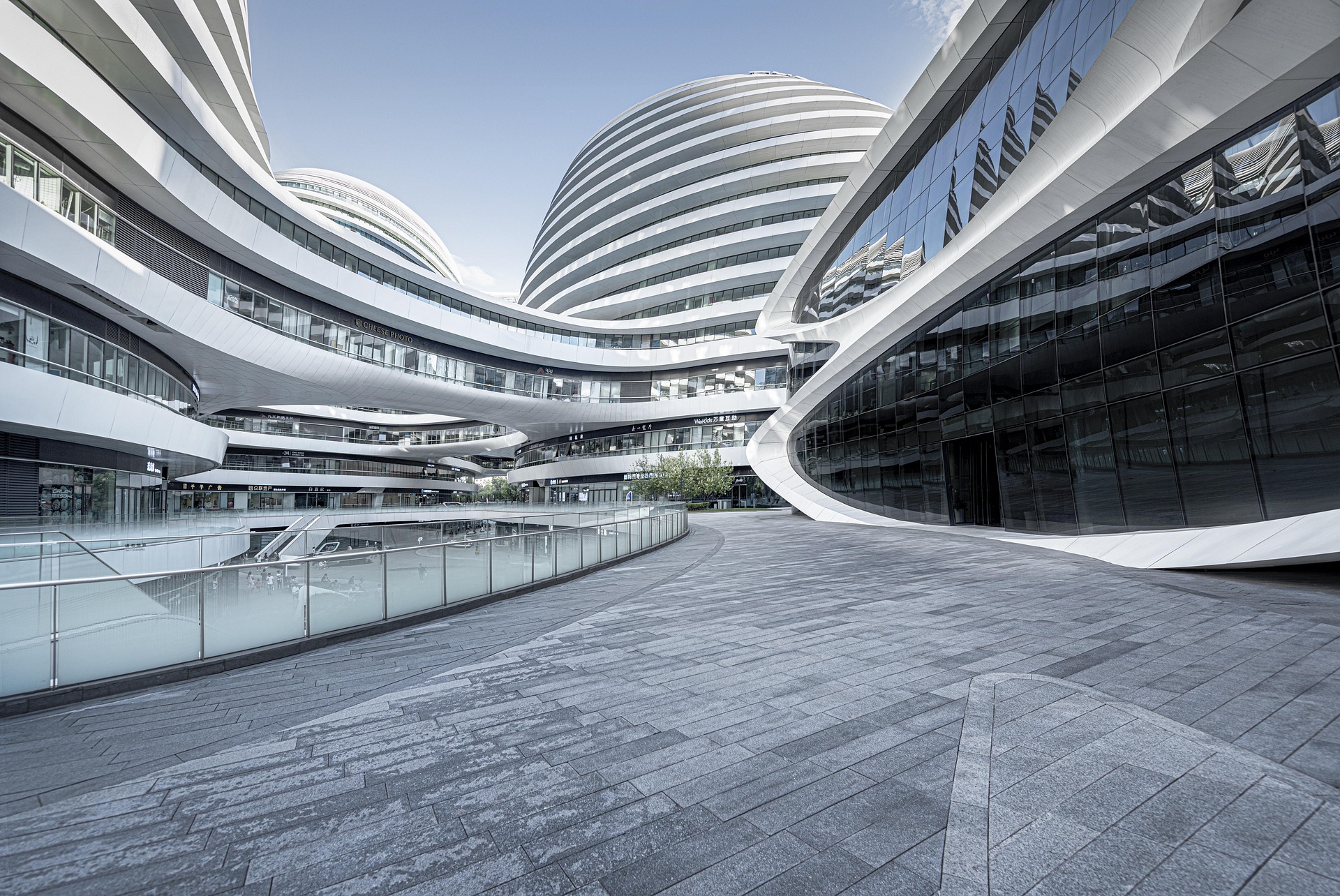an abstract photo of a curved building with a blue sky in the background