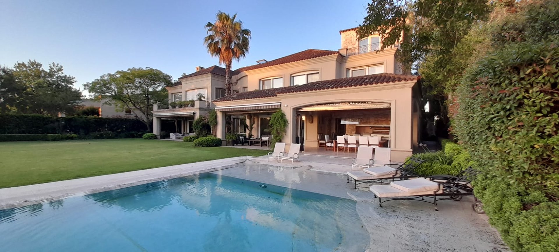an abstract photo of a curved building with a blue sky in the background