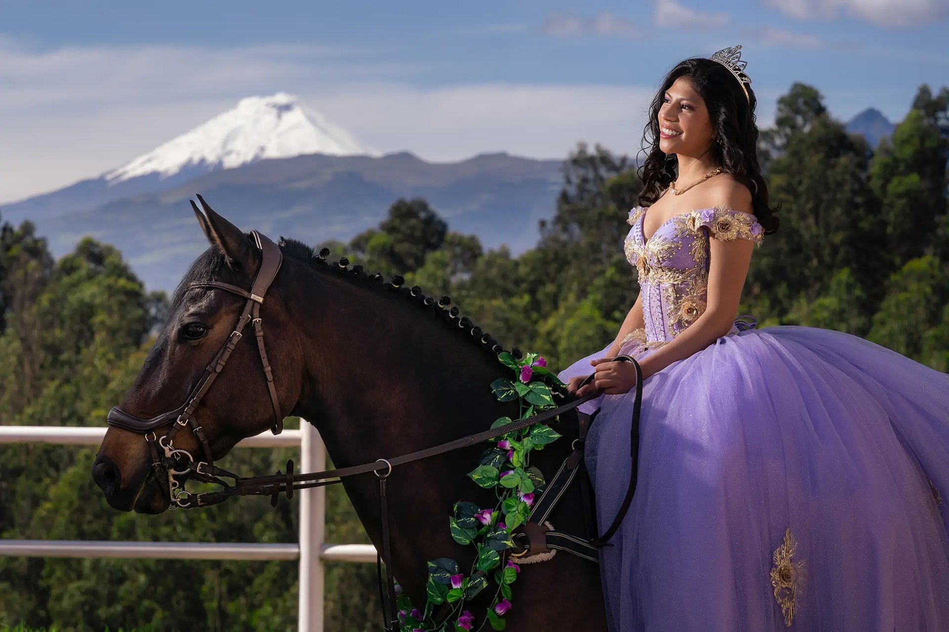 Retrato editorial de quinceañera con vestido morado montando a caballo con el Cotopaxi en Ecuador
