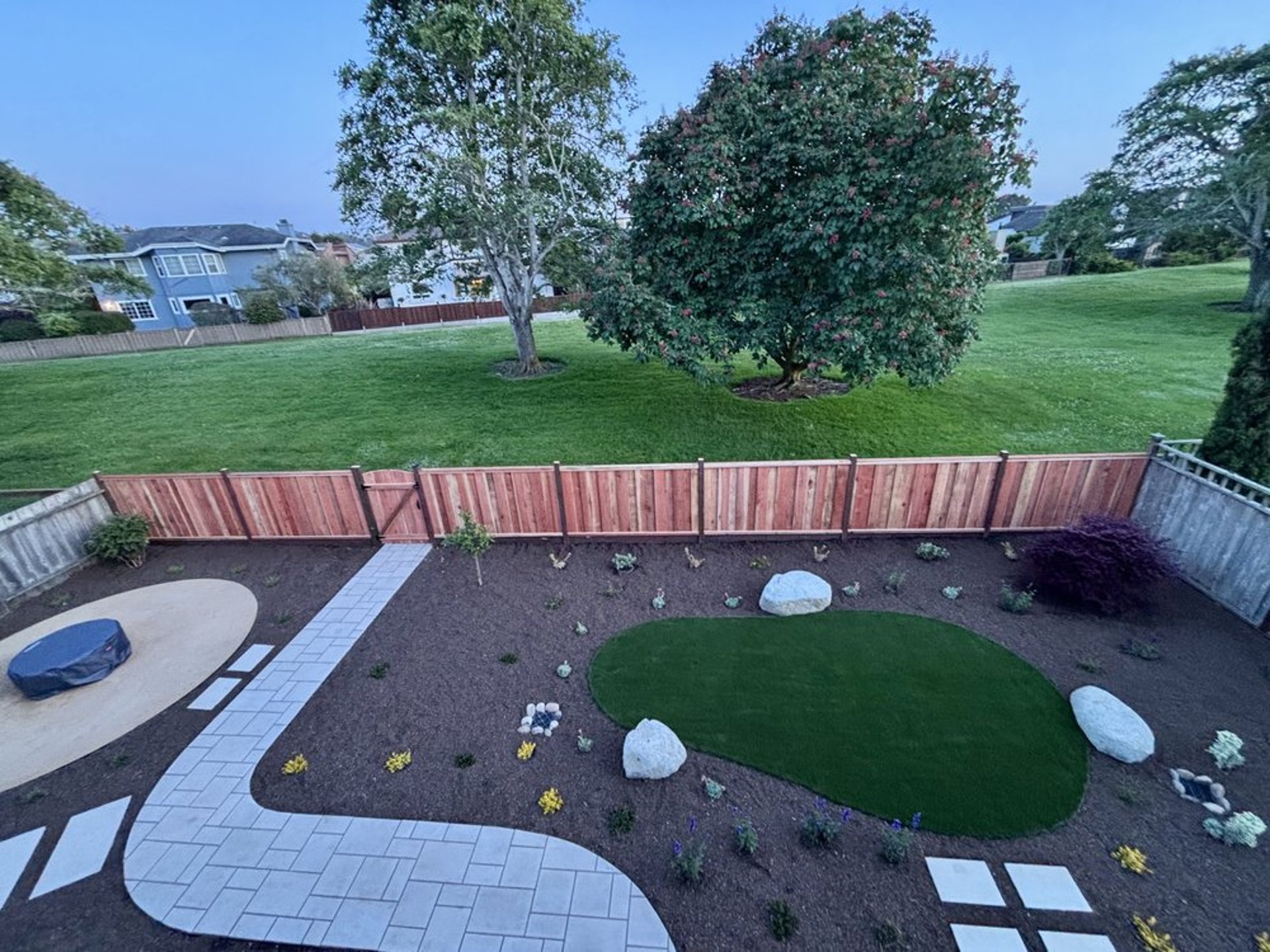 a wooden fence is reflected in the water
