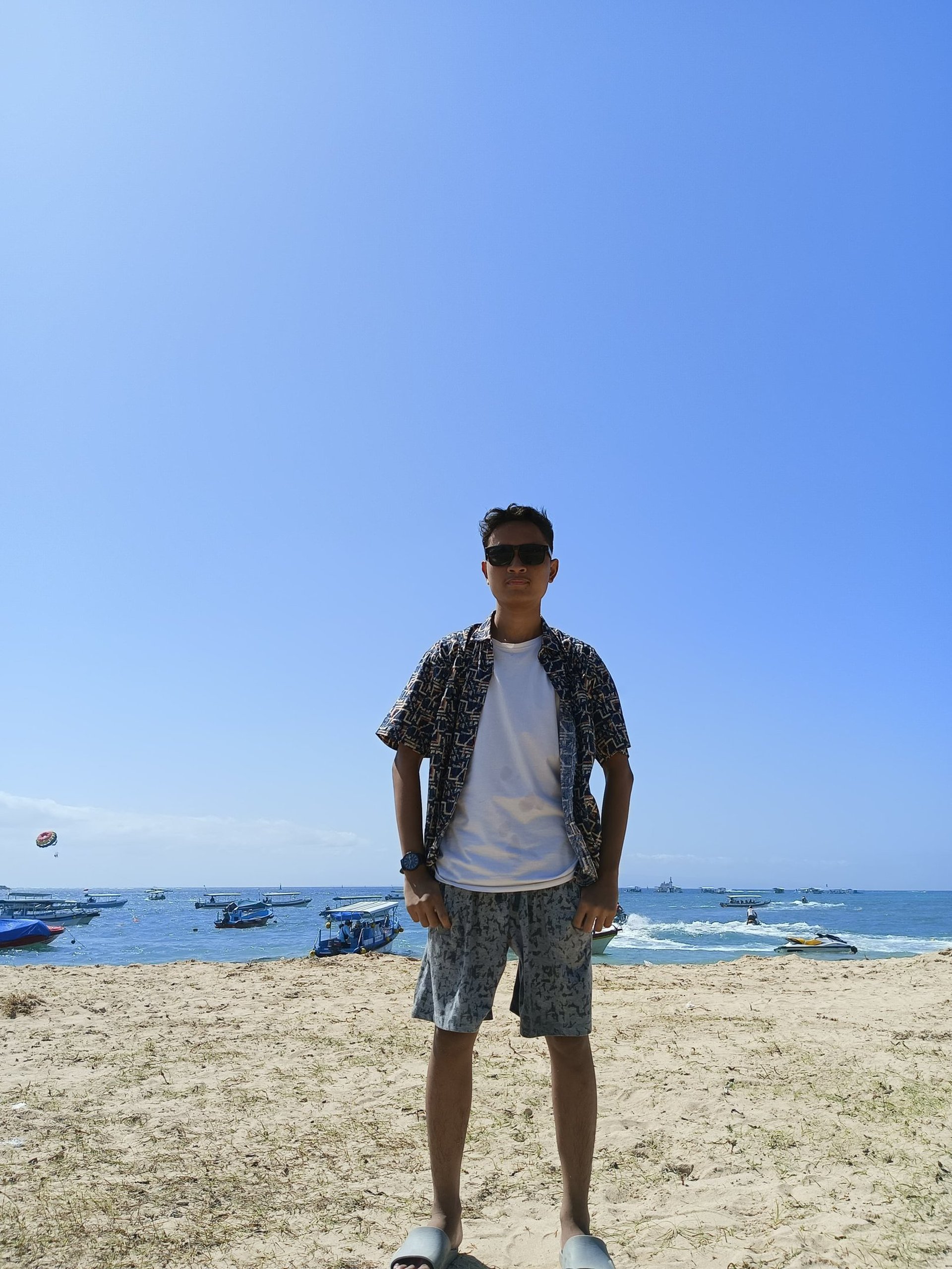 man in white crew neck t-shirt wearing blue cap and black sunglasses