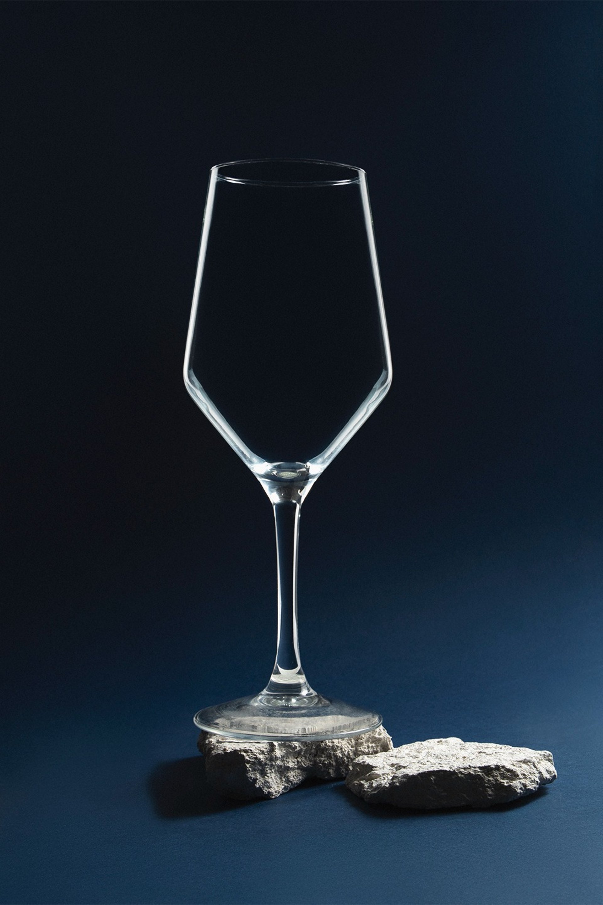 an abstract photo of a curved building with a blue sky in the background