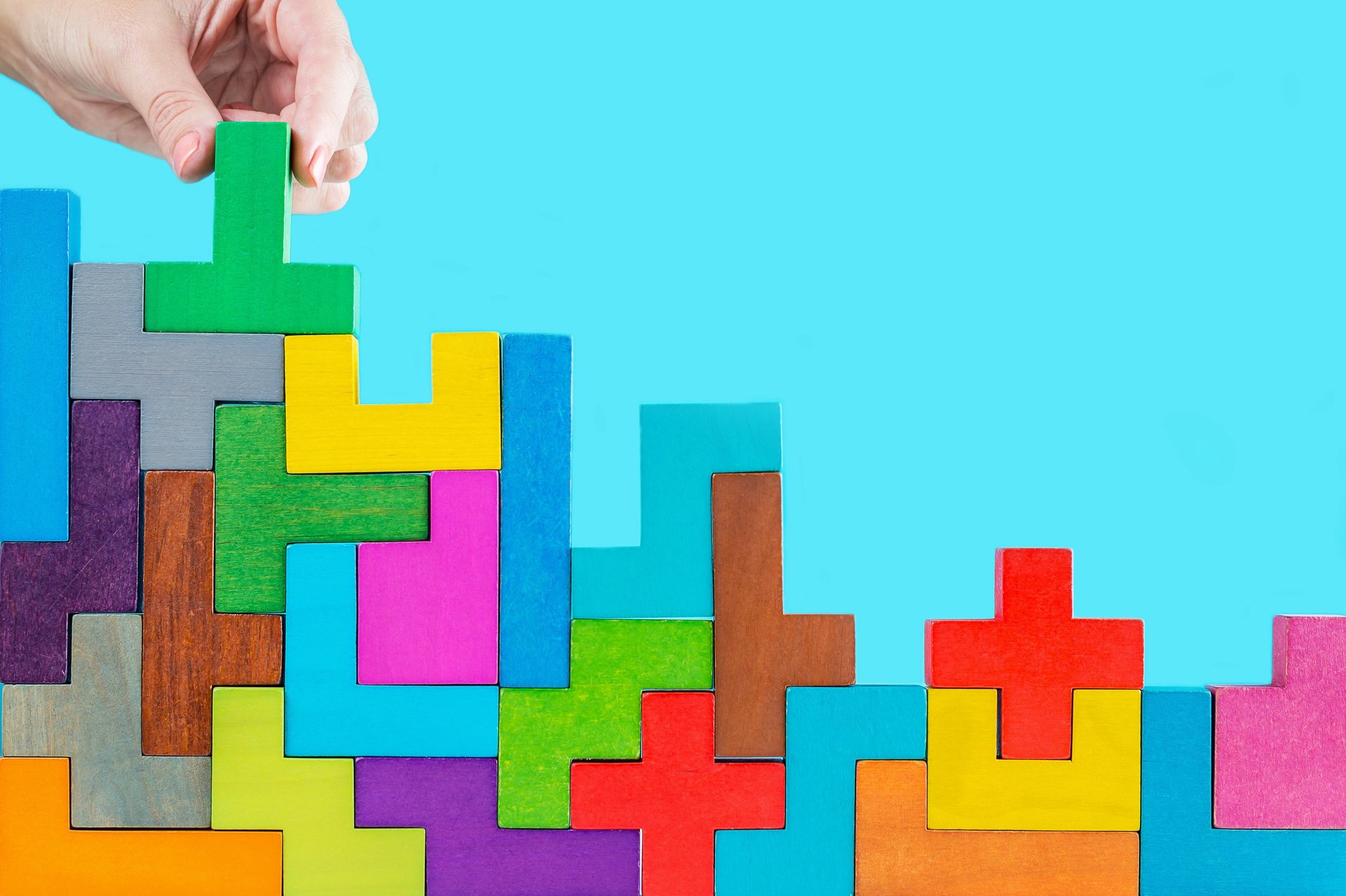 a box of colorful wooden blocks sitting on top of a carpet