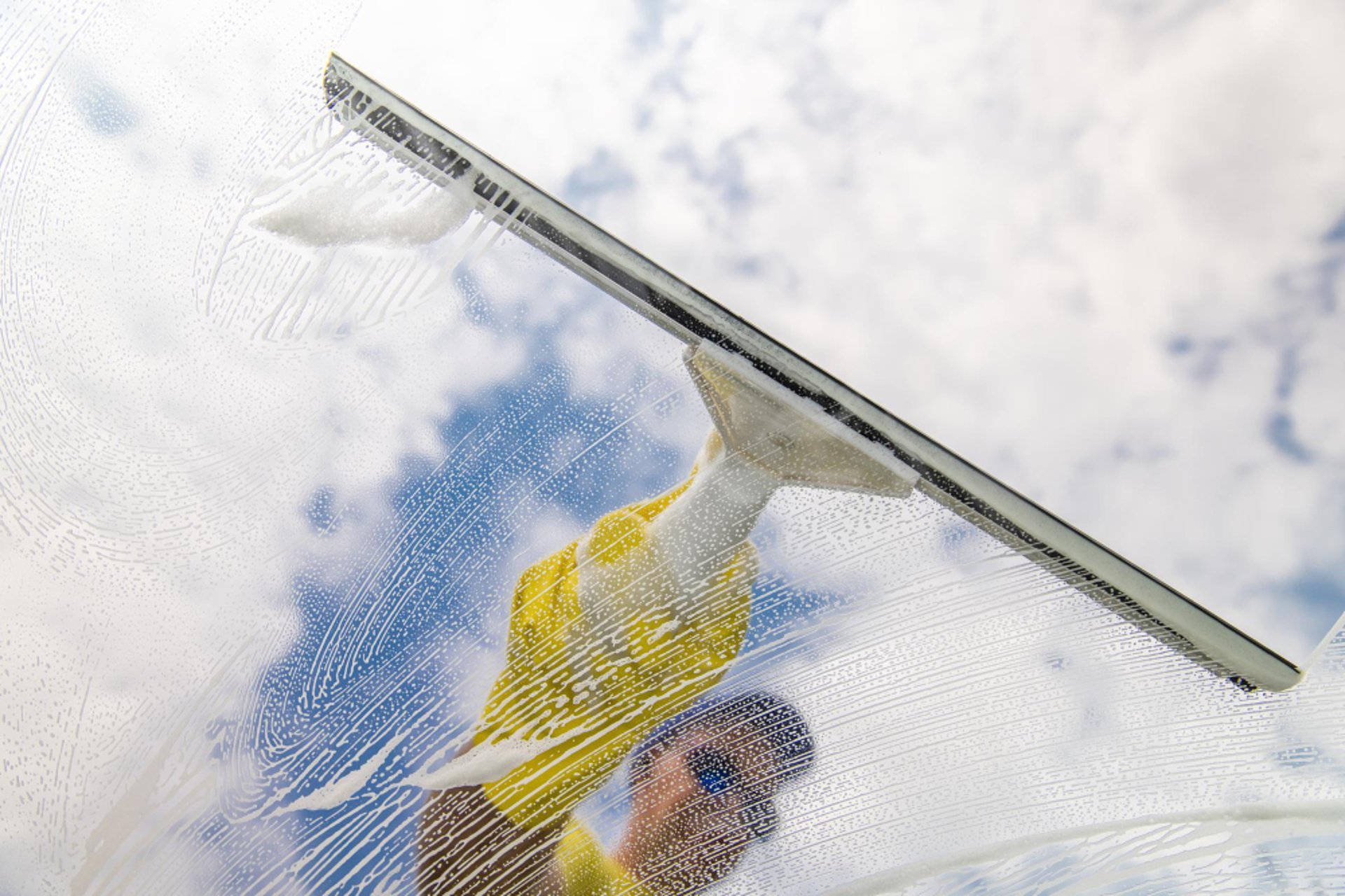 woman wearing yellow long-sleeved dress under white clouds and blue sky during daytime
